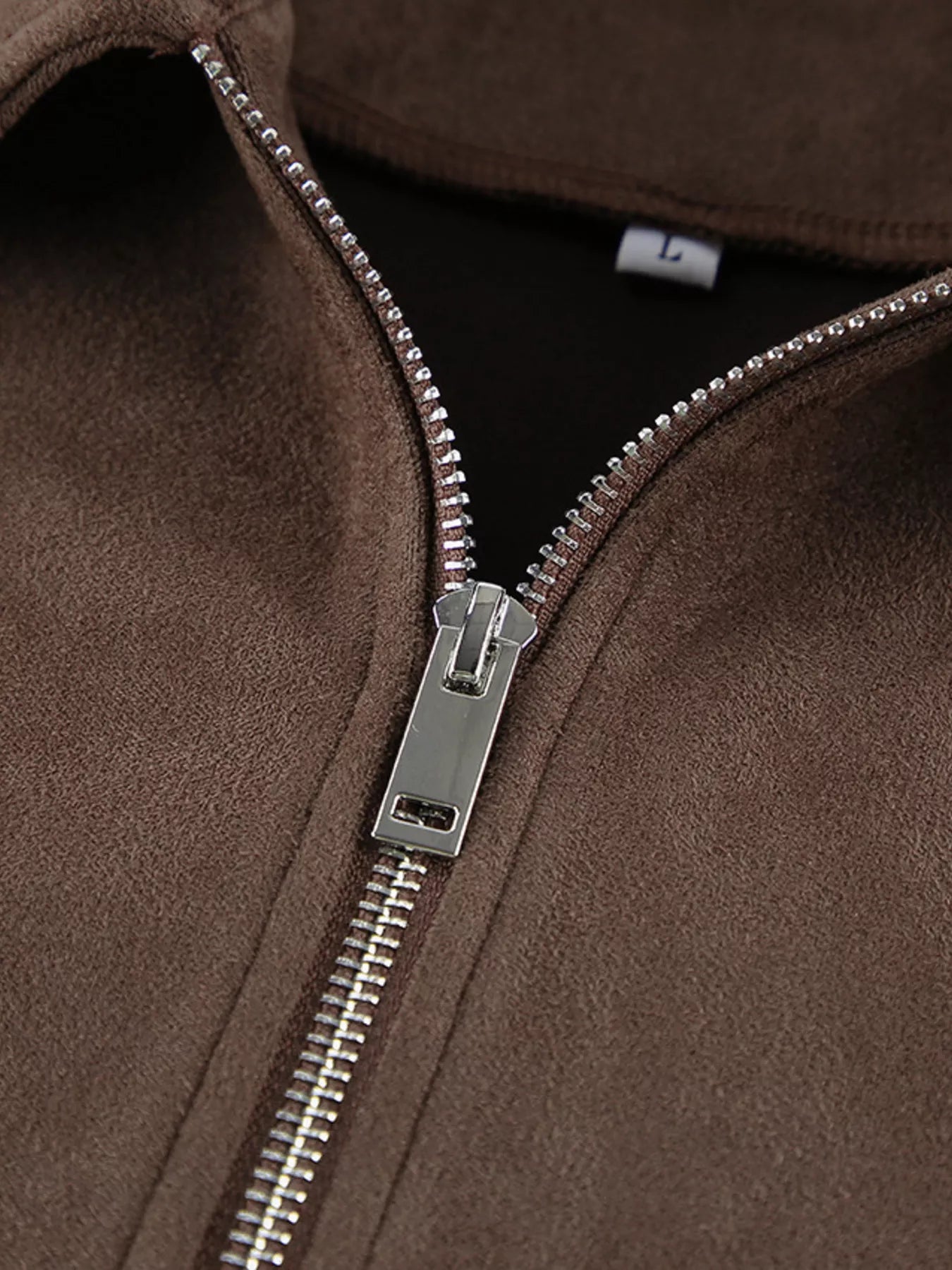 Close-up of the zipper on a Zip-Up Dropped Shoulder Jacket in brown fabric, showcasing the modern relaxed style.