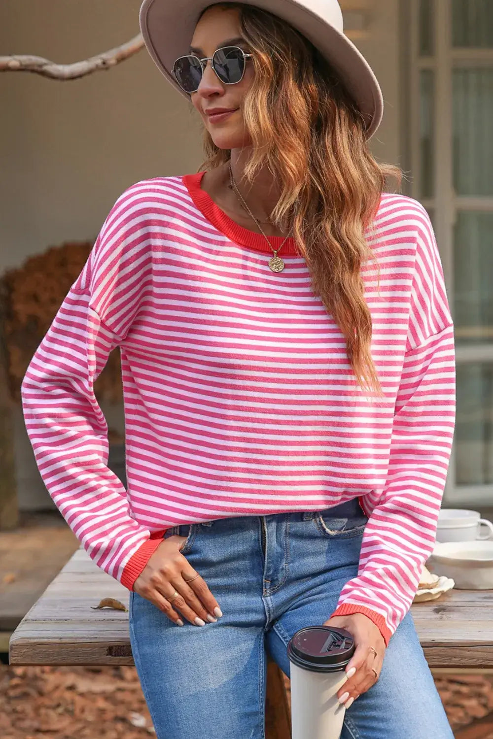 Model wearing a Striped Round Neck Drop Shoulder T-Shirt with a relaxed fit, stylishly paired with jeans and sunglasses.