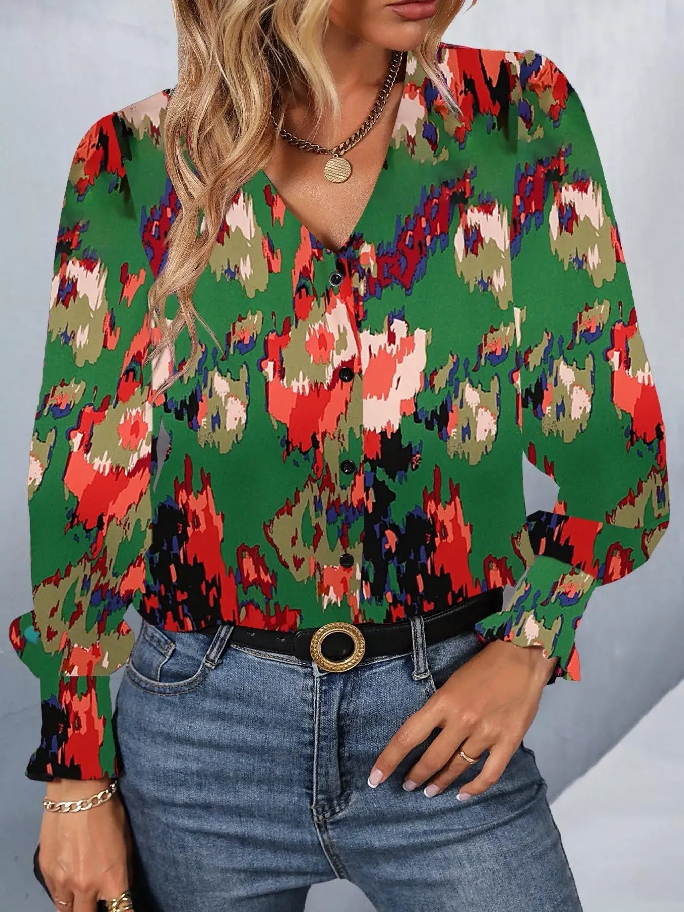 Printed button up long sleeve shirt in vibrant colors, styled with jeans for a casual look.