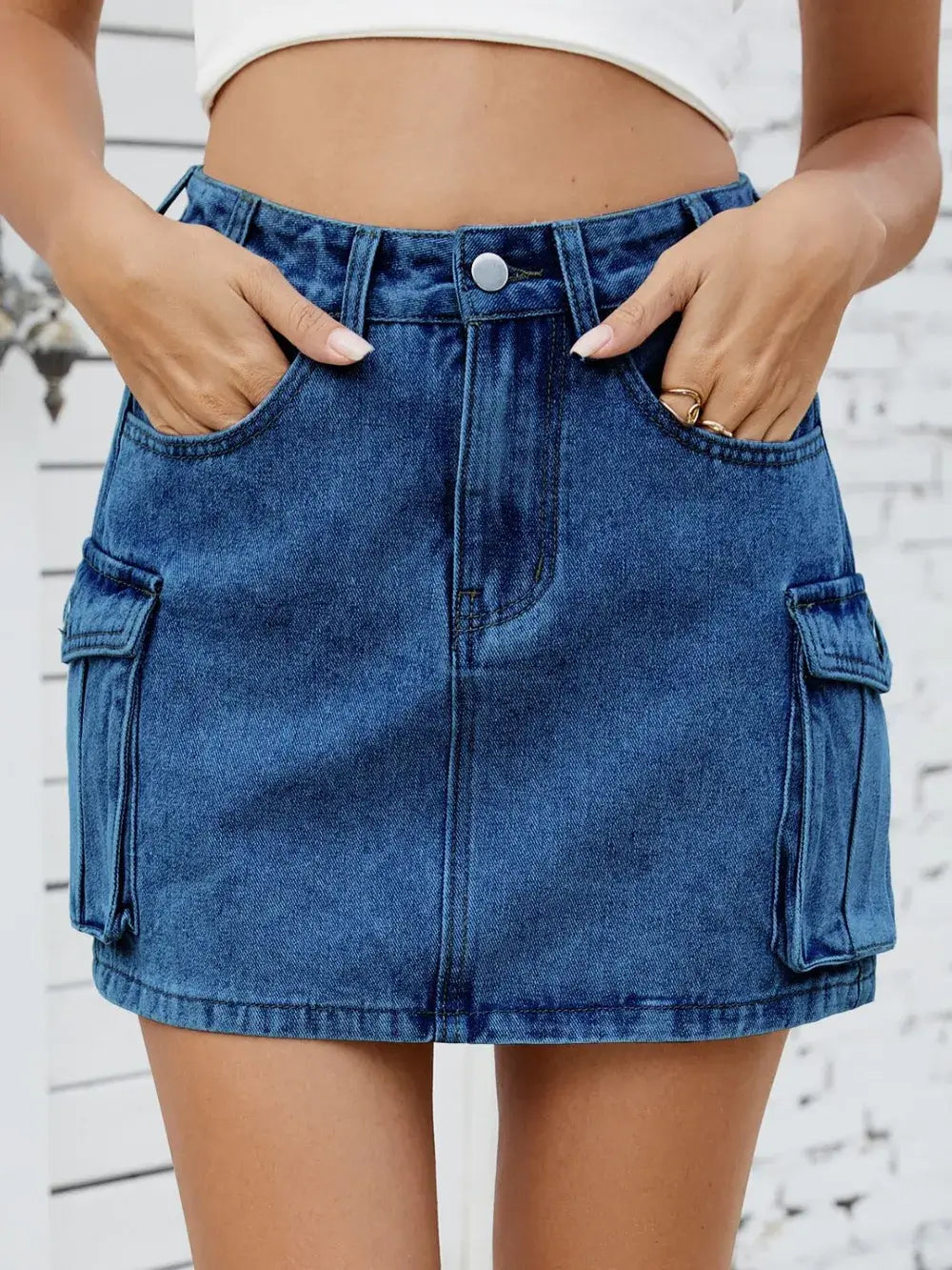 Women's cargo denim skirt featuring functional pockets and a stylish design, perfect for casual and trendy looks.