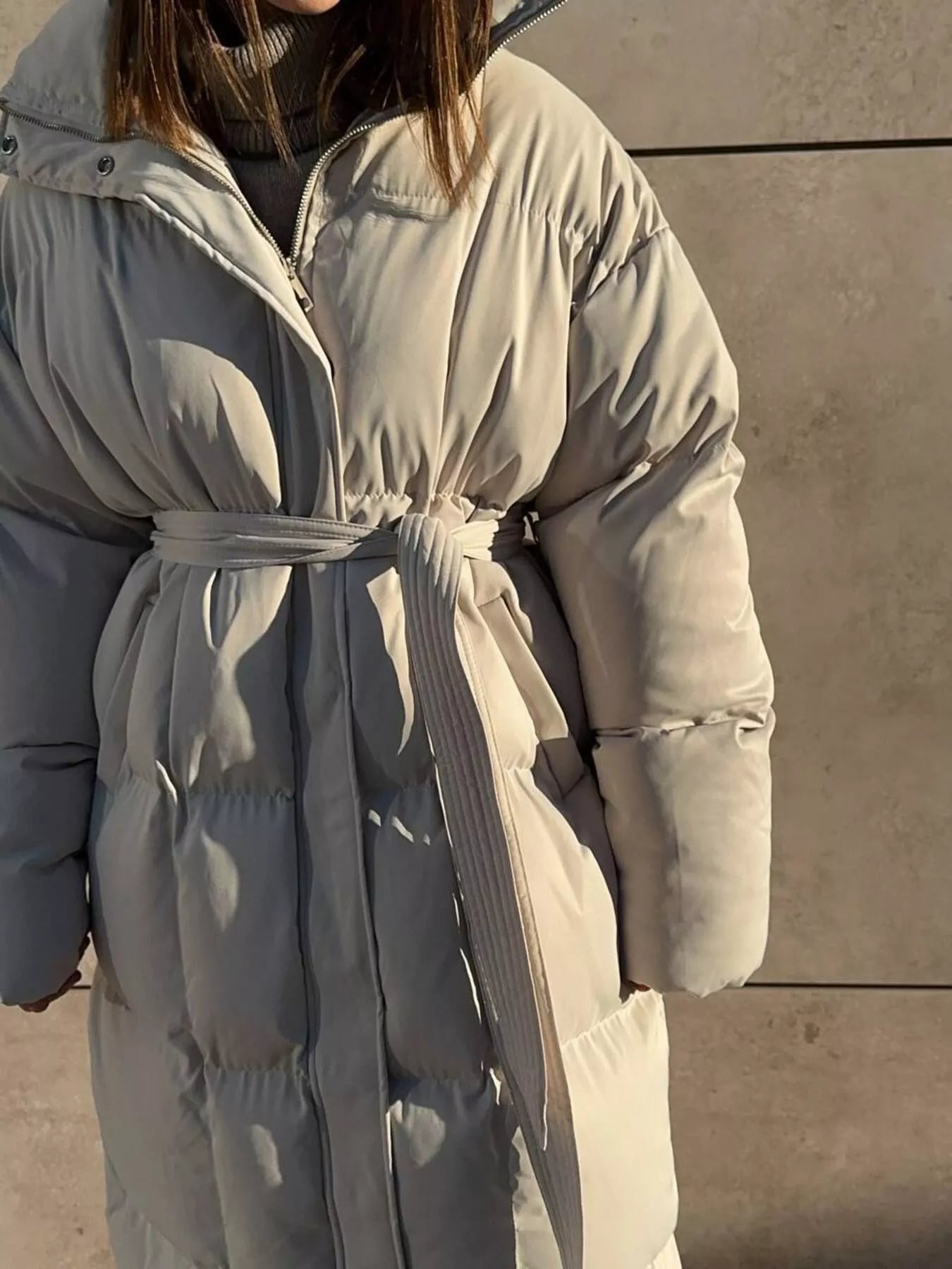 Longline Padded Winter Coat Belted with pockets, zipper, and soft lining, perfect for warmth in winter.