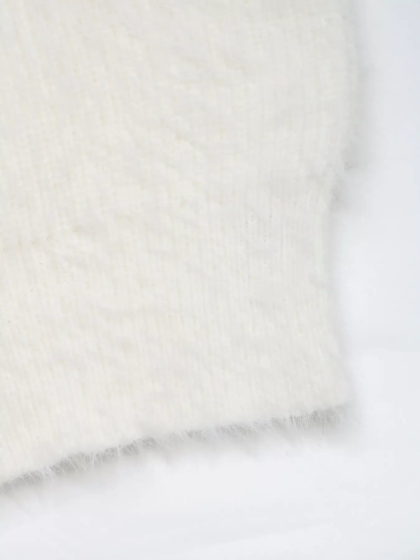 Close-up of the soft ribbed texture of the Bow Scoop Neck Cropped Cami in white.