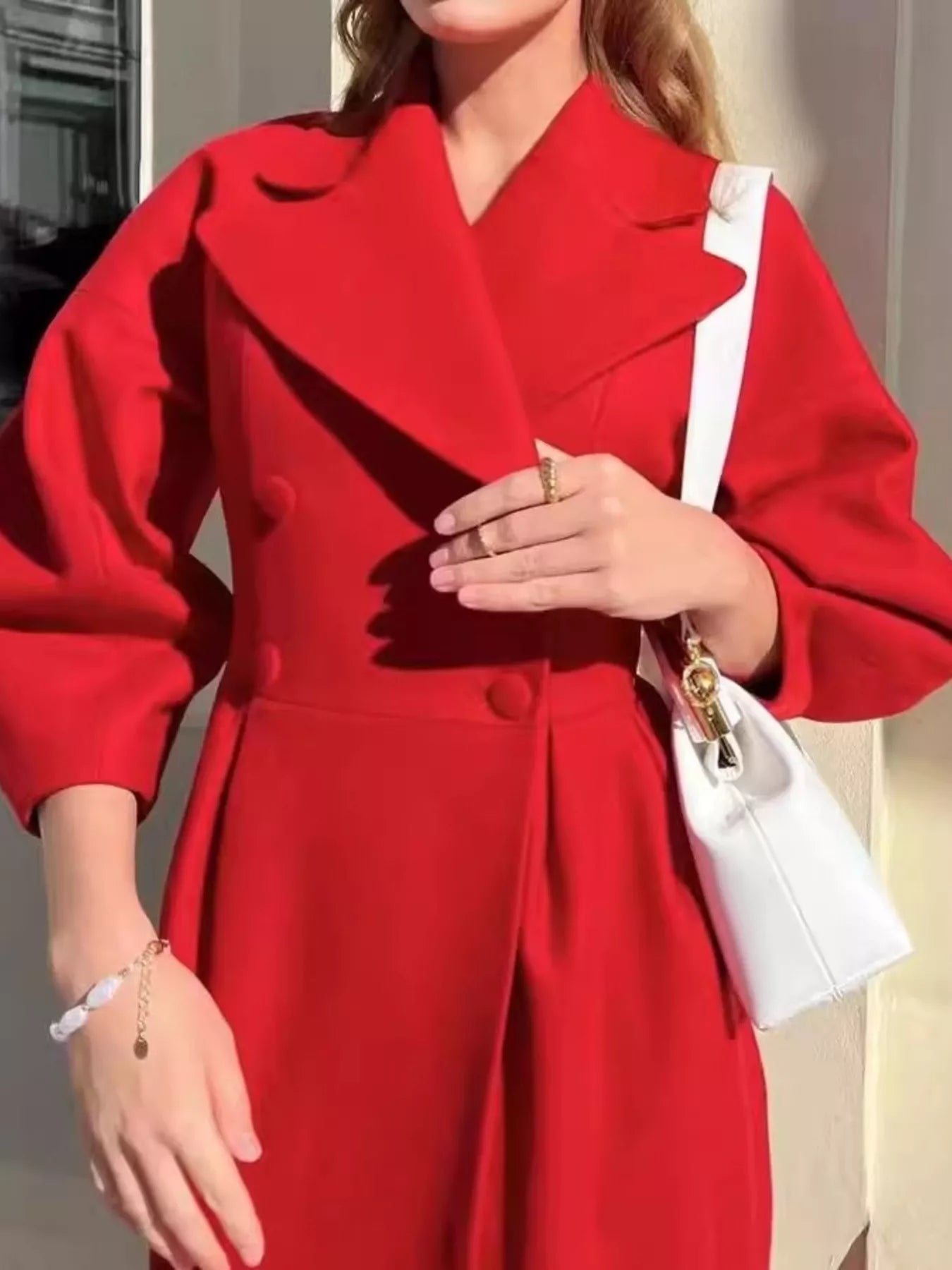 Double-Breasted Longline Coat in vibrant red with buttoned front and elegant tailored silhouette.