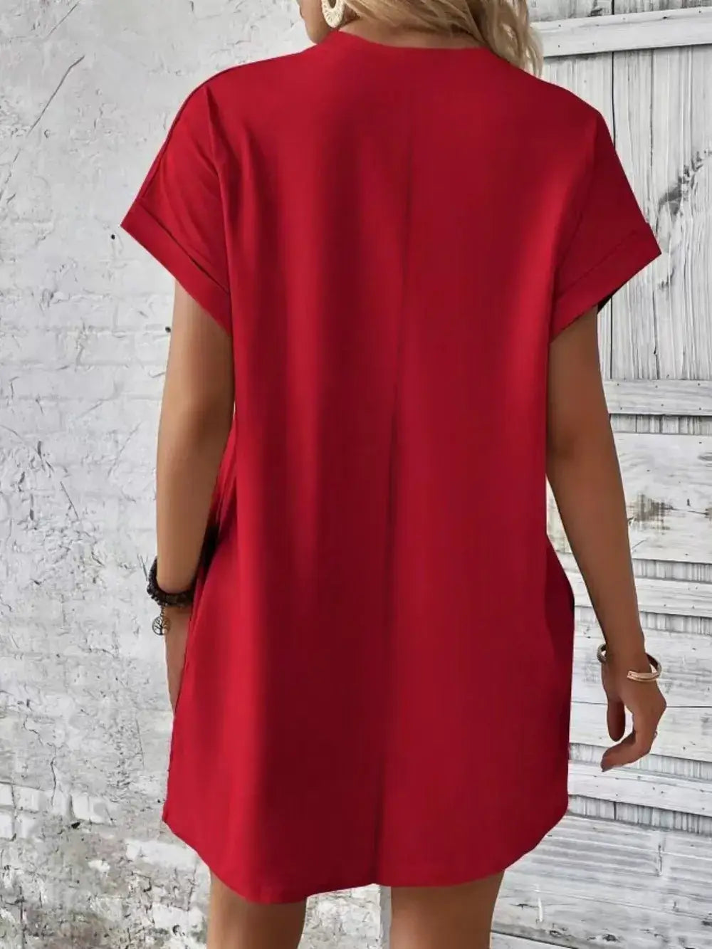 Back view of a red pocketed round neck short sleeve dress, showcasing its casual style and comfortable fit.