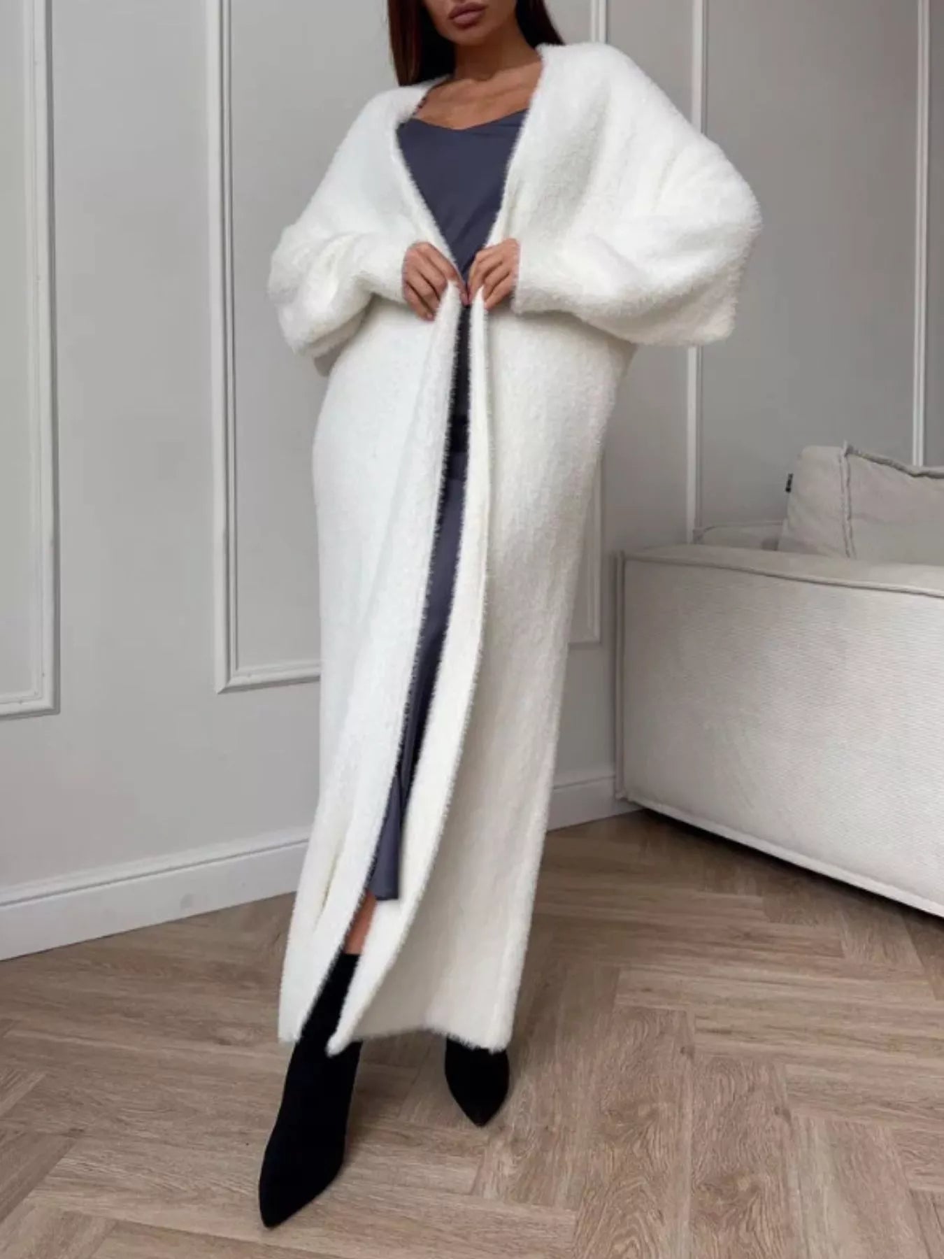 Fuzzy Open Front Longline Cardigan model wearing a cozy white cardigan with a gray outfit, showcasing longline style.
