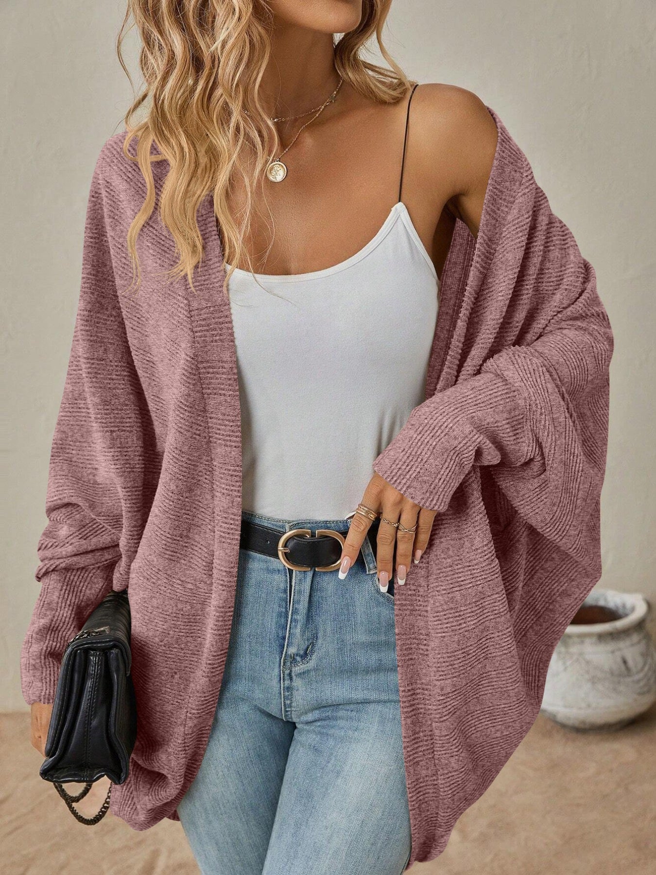 Model wearing an Open Front Batwing Sleeve Cardigan in mauve, styled with a white tank top and light blue jeans.
