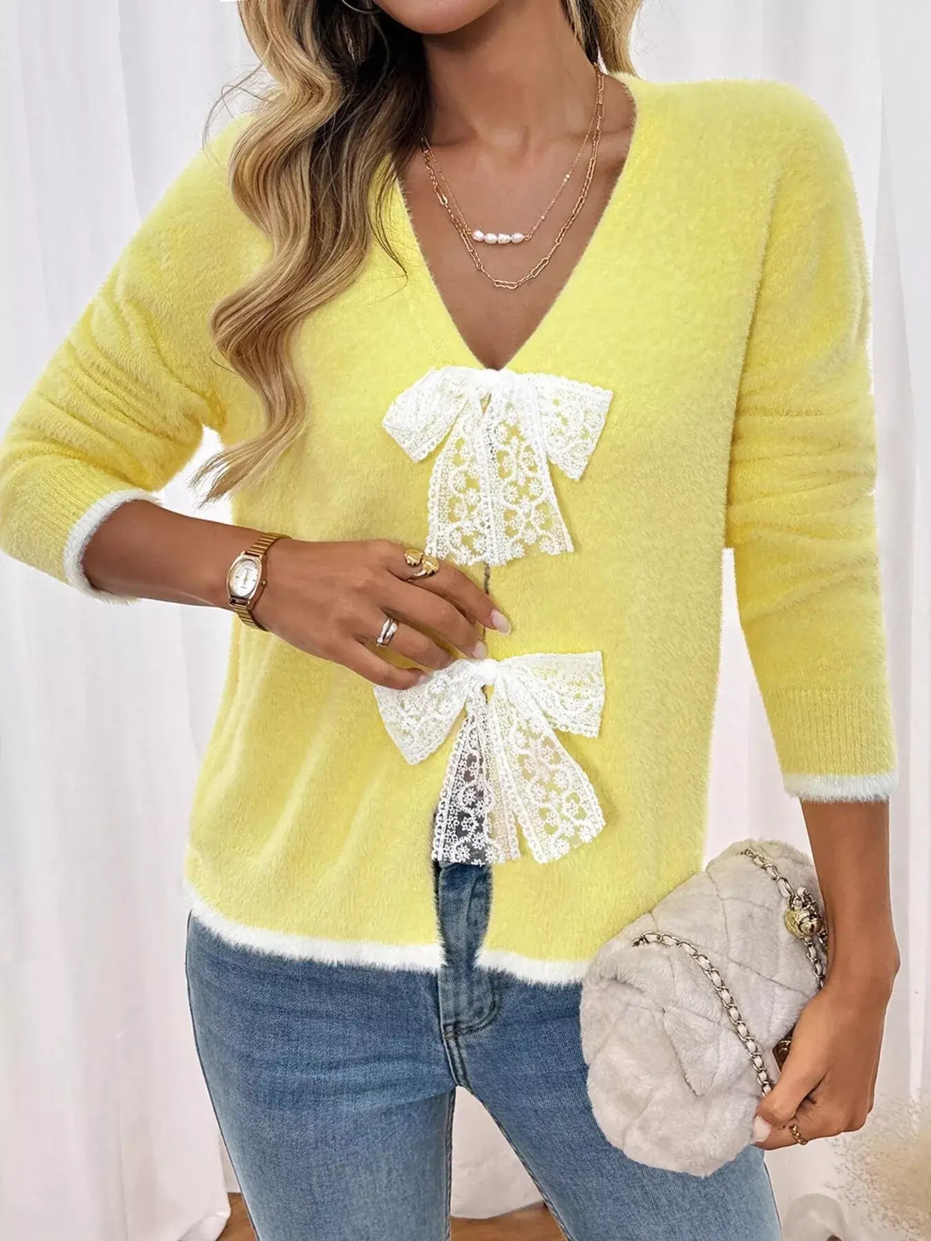 Lace Bow-Tie Front Long Sleeve Cardigan in yellow with lace bow details and long sleeves, styled with jeans.