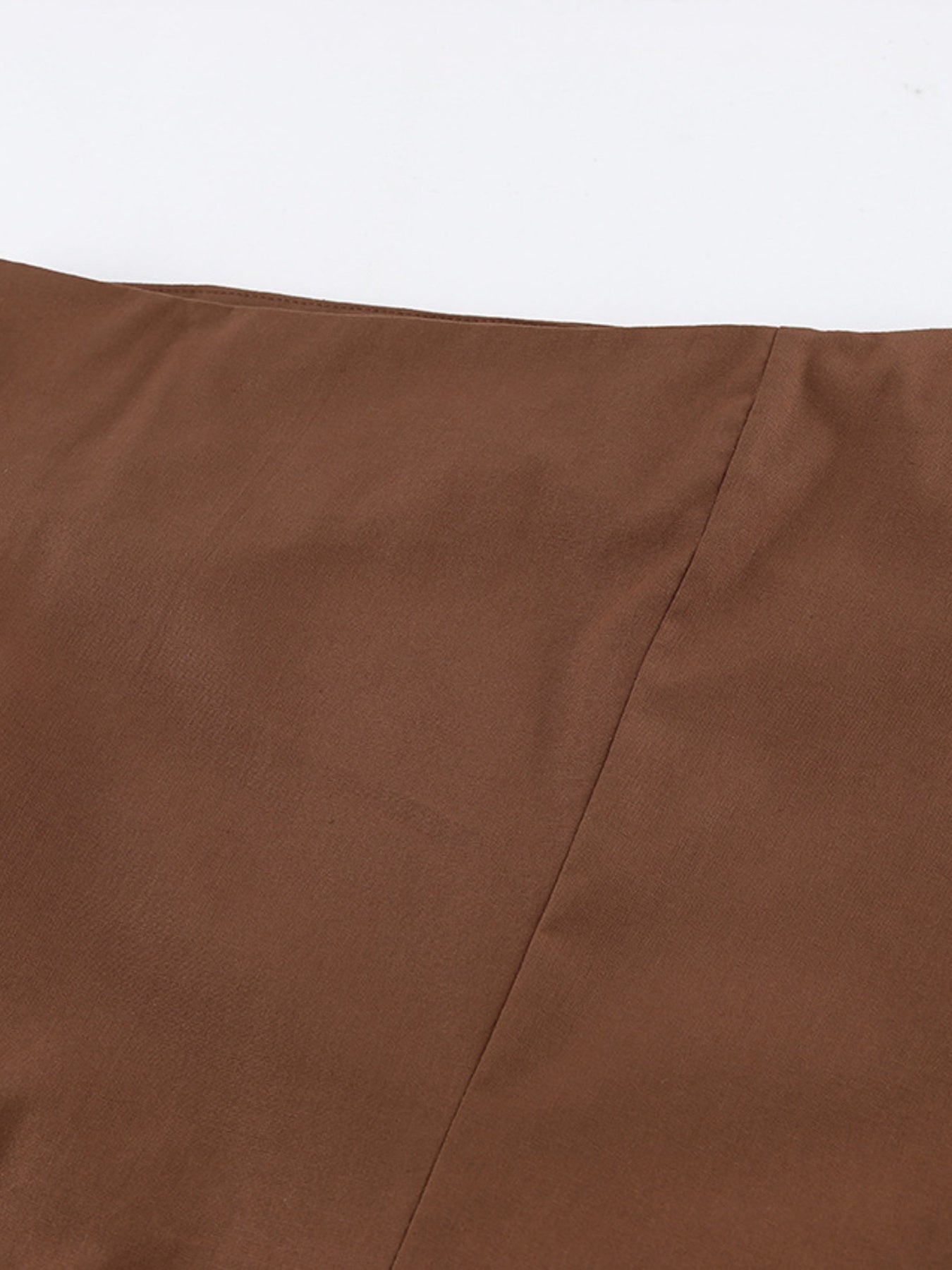 Close-up of the fabric texture of a brown One Shoulder Top and Shorts Set, showcasing its smooth finish and quality material.