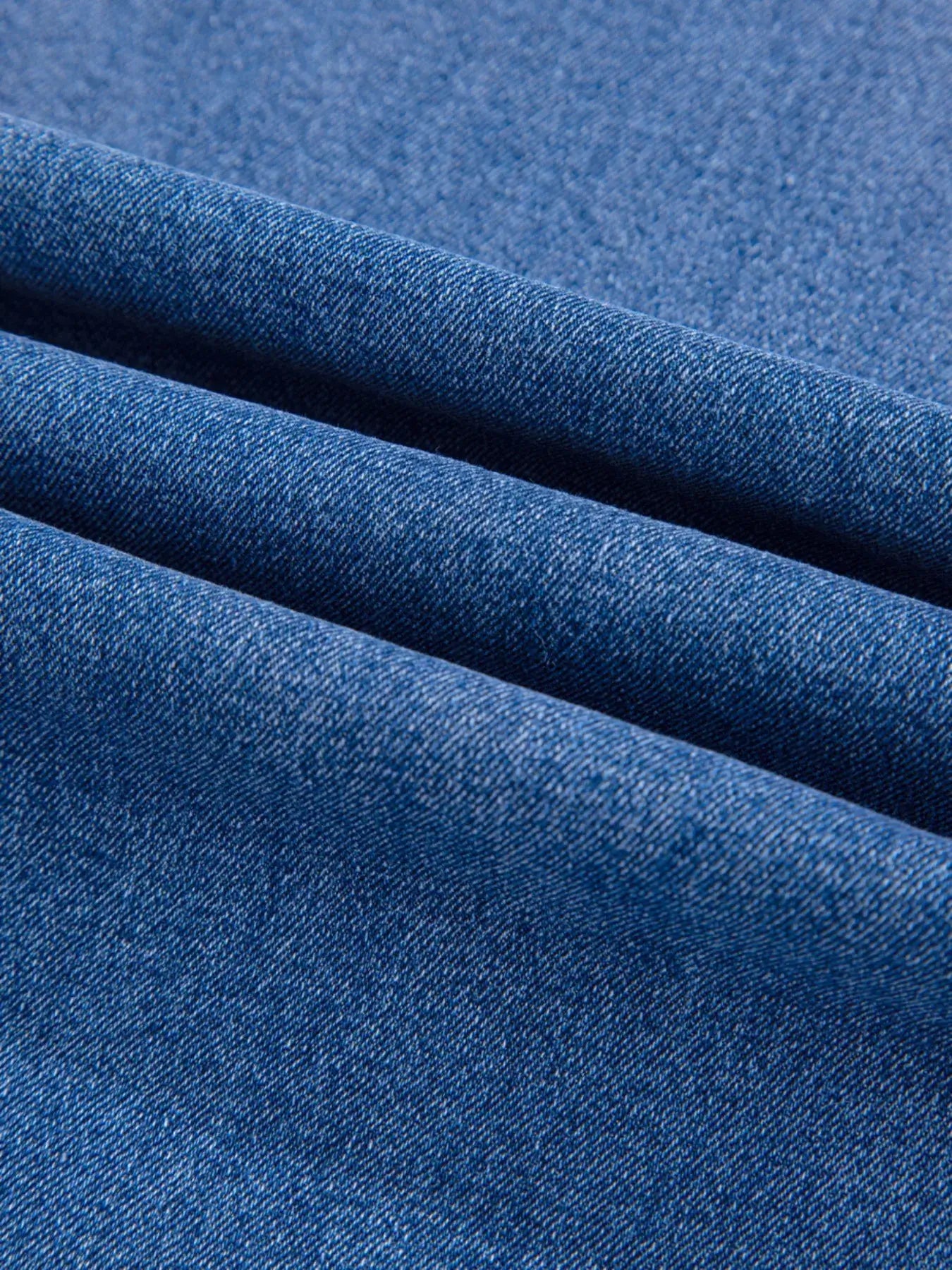 High-Waisted Wide Leg Flare Jeans fabric close-up, showcasing the denim texture and color.