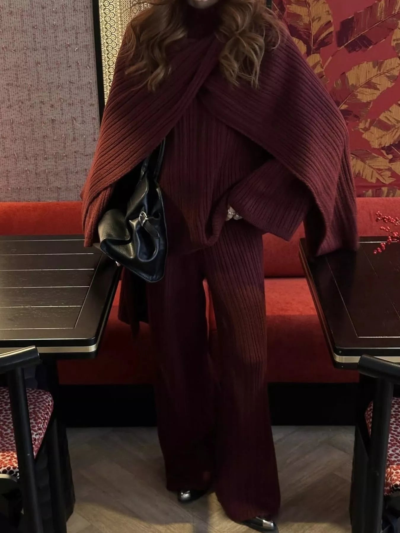 3 Piece Ribbed Sweater and Wide Leg Pants Set with Scarf modeled in a stylish restaurant setting.
