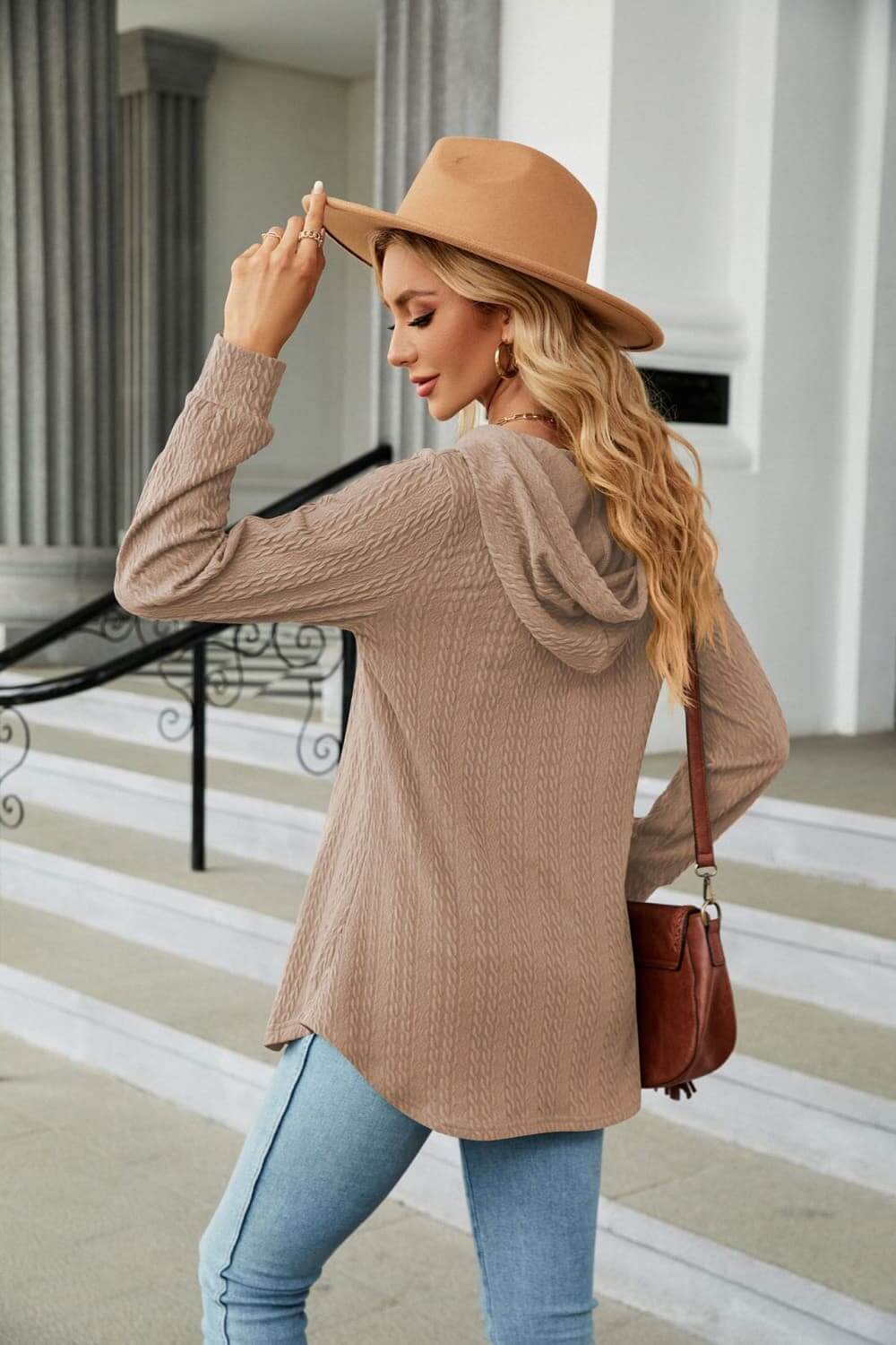 Woman wearing a Long Sleeve Hooded Blouse with a hat, showcasing a casual and cozy style outdoors.
