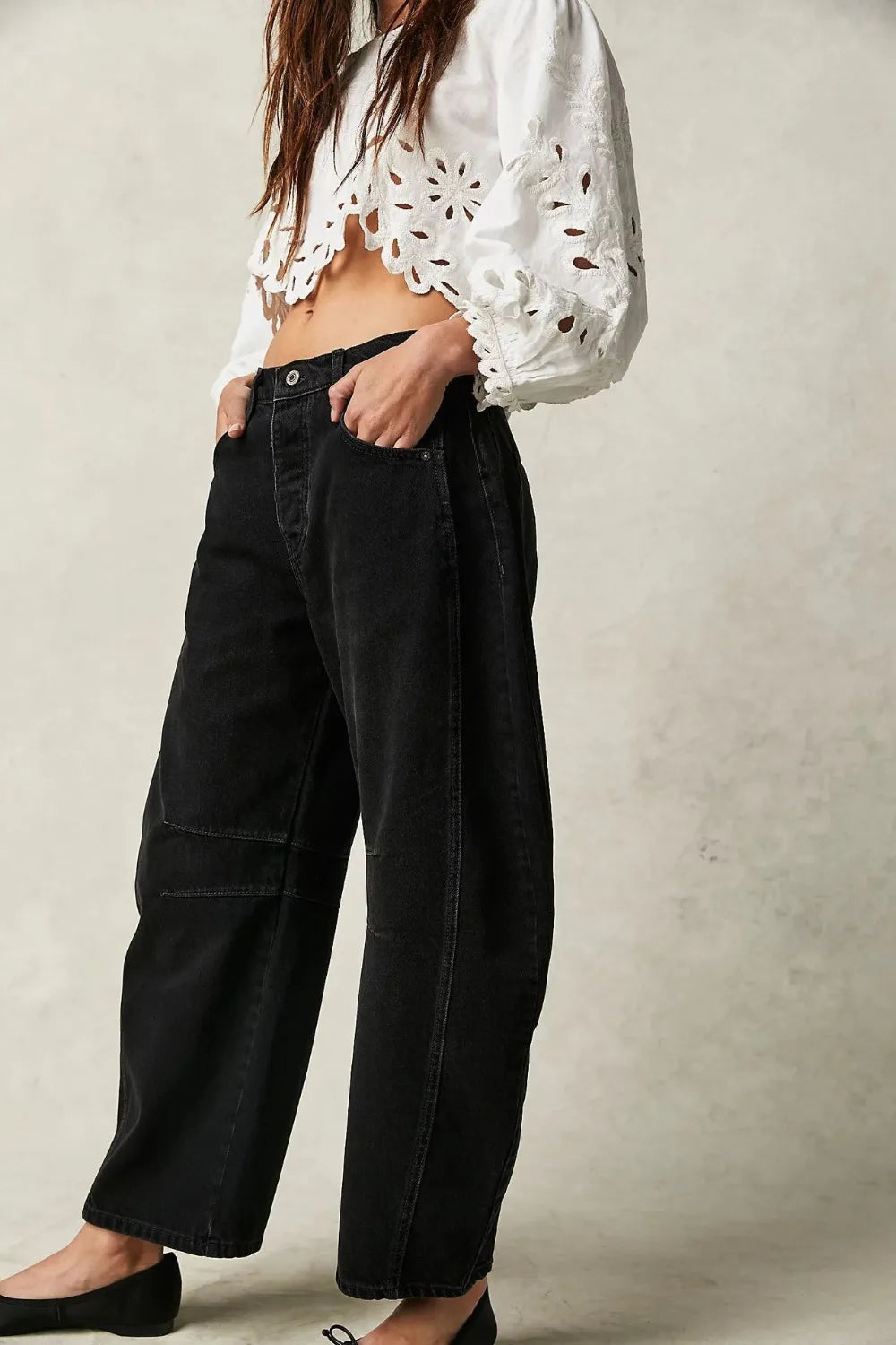 Model wearing Wide Leg Jeans with Pockets styled for casual look, featuring a white cropped top and black jeans.