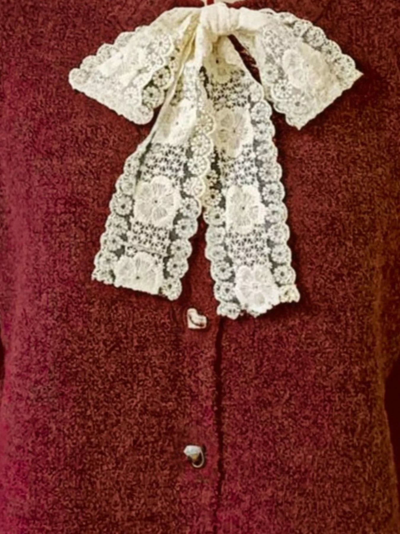 Lace Bowknot Knit Cardigan featuring a delicate lace bow on a burgundy background, perfect for feminine everyday style.