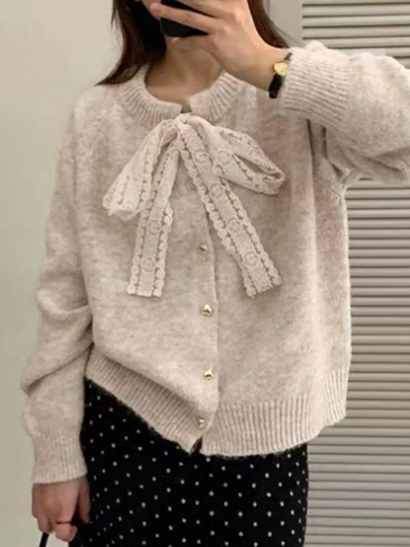 Lace Bowknot Knit Cardigan styled with a bow and buttoned front, perfect for feminine everyday wear.