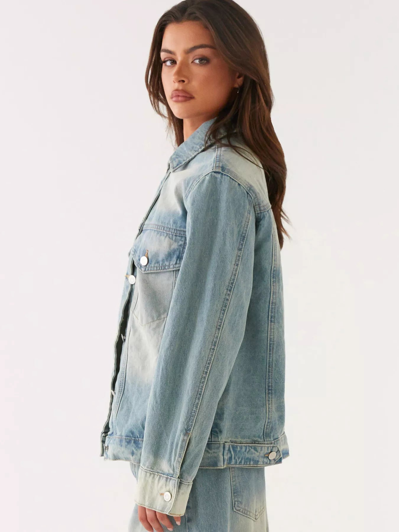 Model wearing a Button Up Denim Jacket and Jeans Set, showcasing a stylish side profile view.