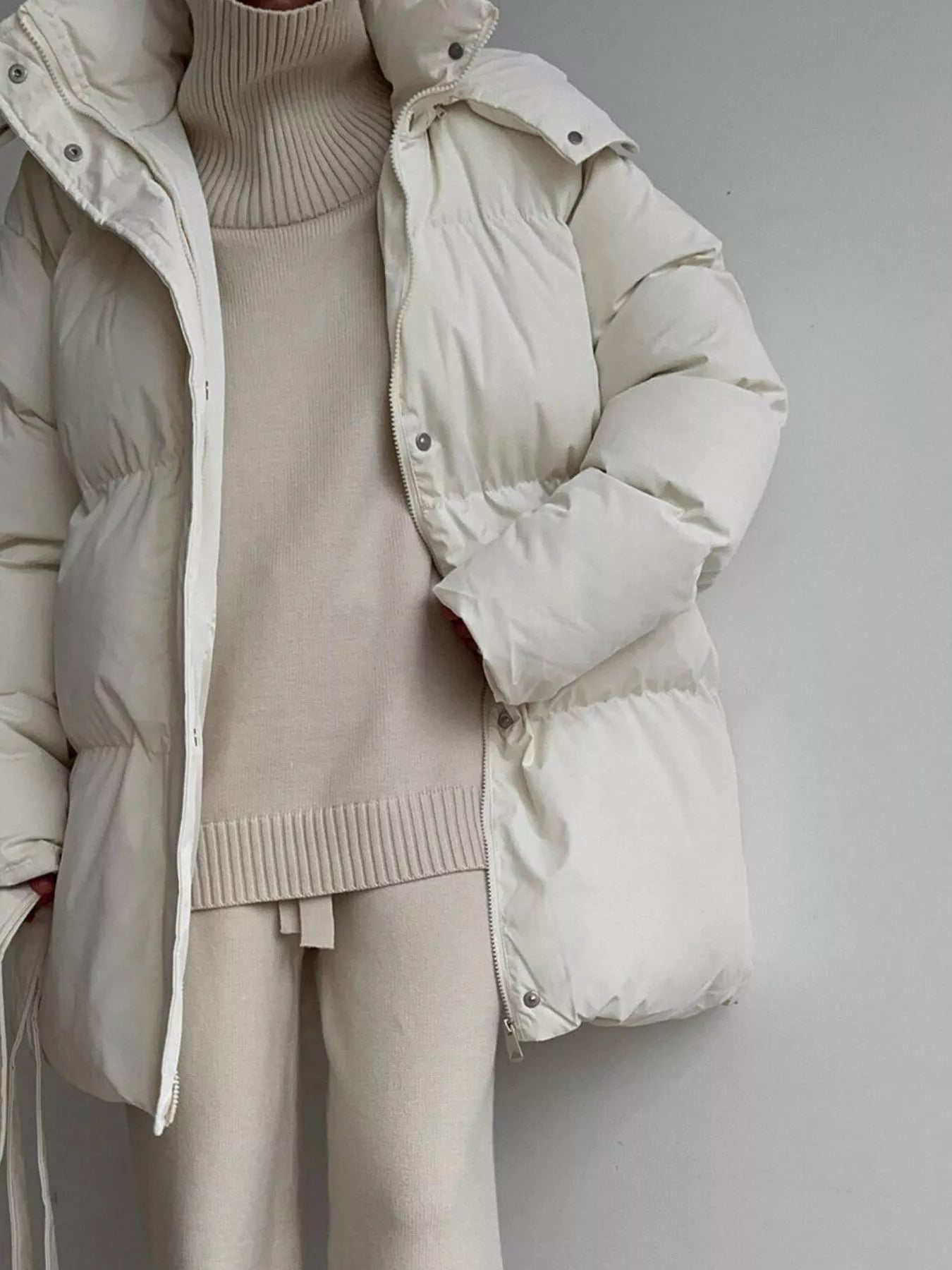 Mid Length Hooded Winter Coat Belted Warm Women Jacket worn over light sweater and pants in a neutral color.