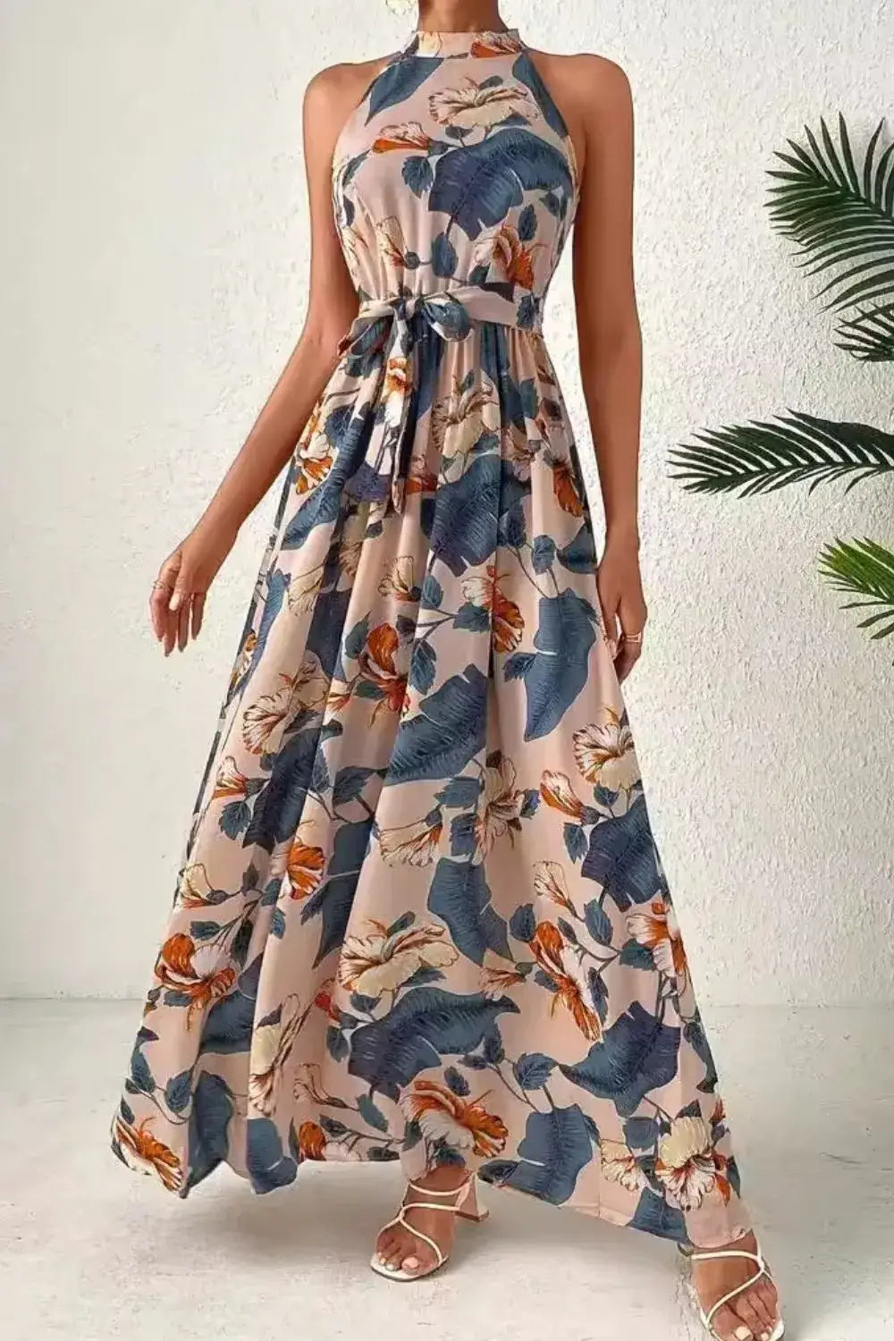 Tied Floral Sleeveless Dress displayed in a feminine floral pattern, perfect for summer events and casual wear.