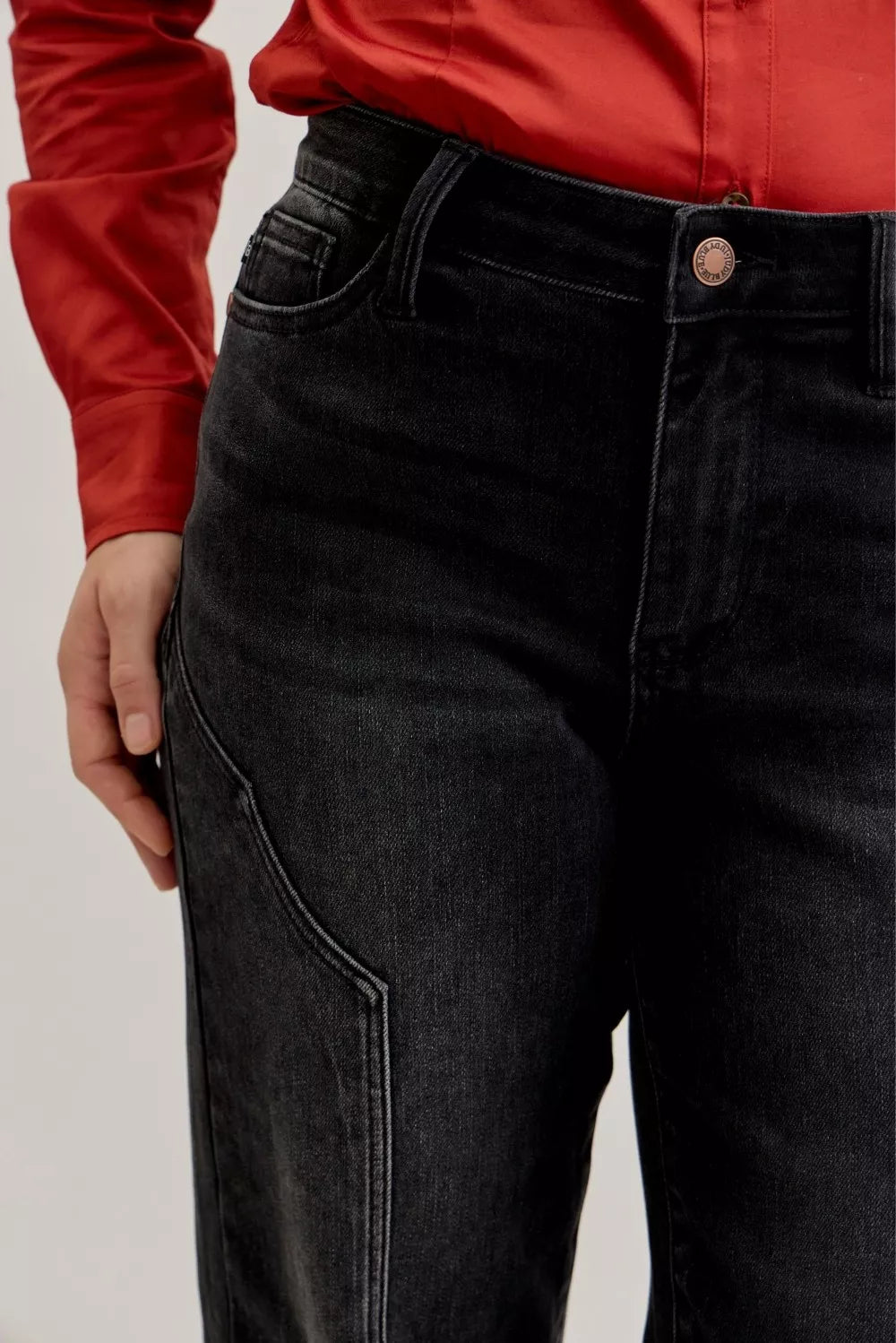 Judy Blue Mid Rise Straight Western Seam Jeans in dark wash with stylish western seam detailing worn with a red top.