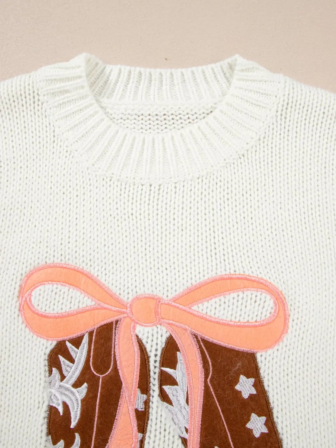 Embroidered bow boots graphic drop shoulder sweater featuring pink bow and graphic design on cozy knit.