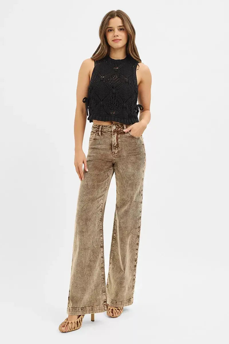 Model showcasing RISEN High Rise Wide Leg Corduroy Jeans in brown with a black cropped top, highlighting a stylish retro look.