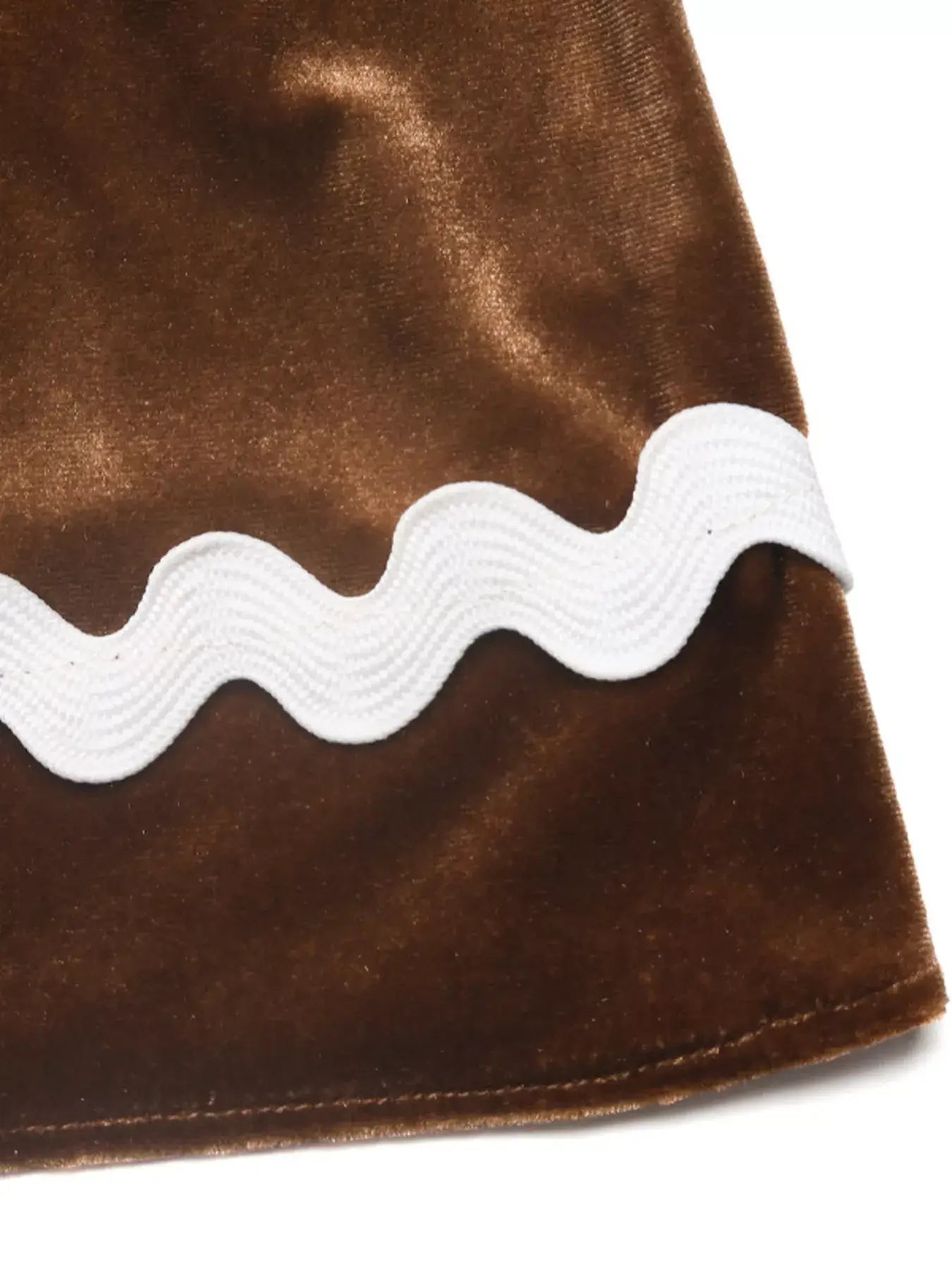 Close-up of the Velvet Tiered Midi Skirt showcasing soft brown velvet and white wavy trim detail.