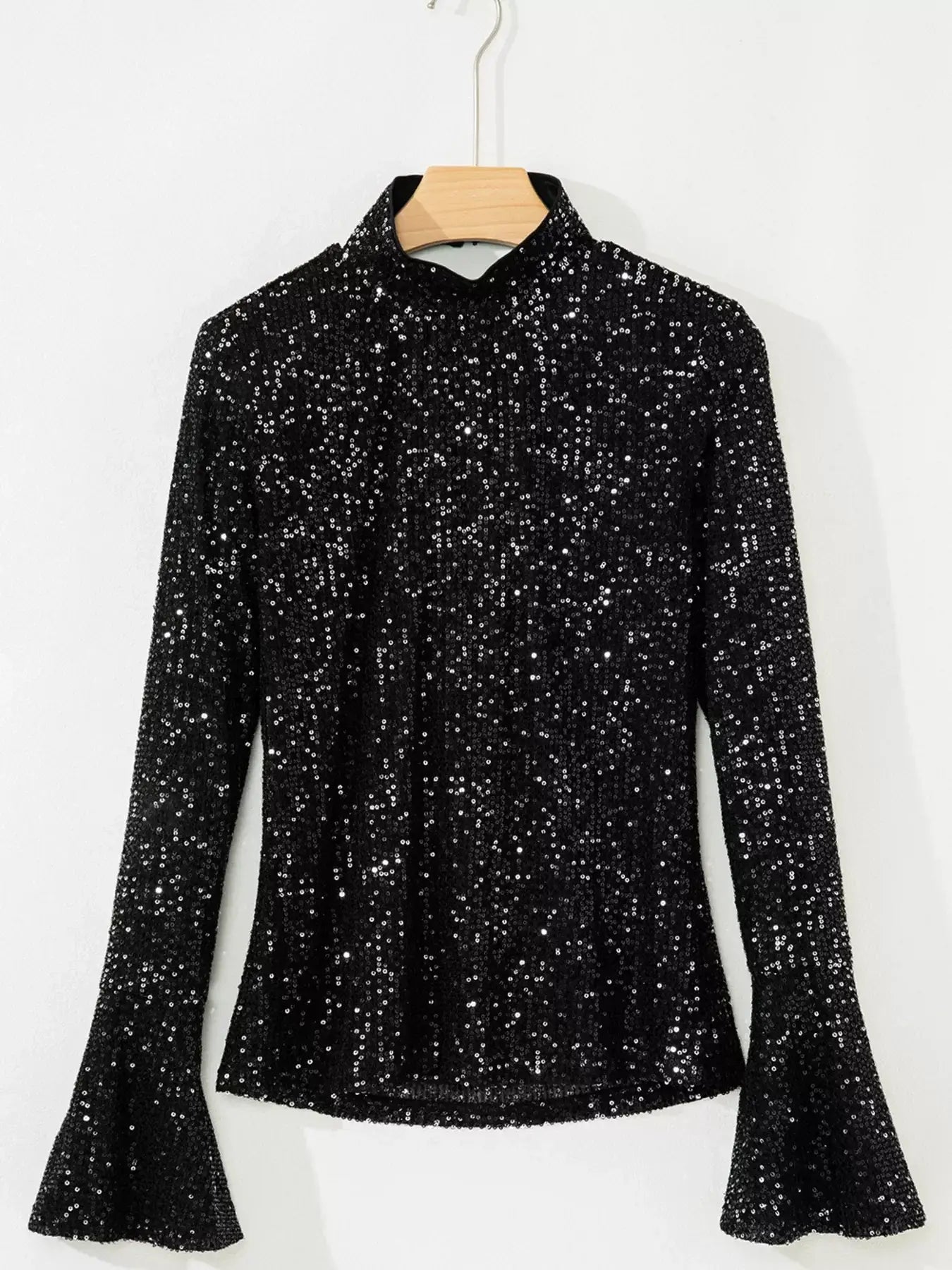 Sequin Mock Neck Drape Open Back Bell Sleeve Top hanging display with shimmering sequins and elegant design.