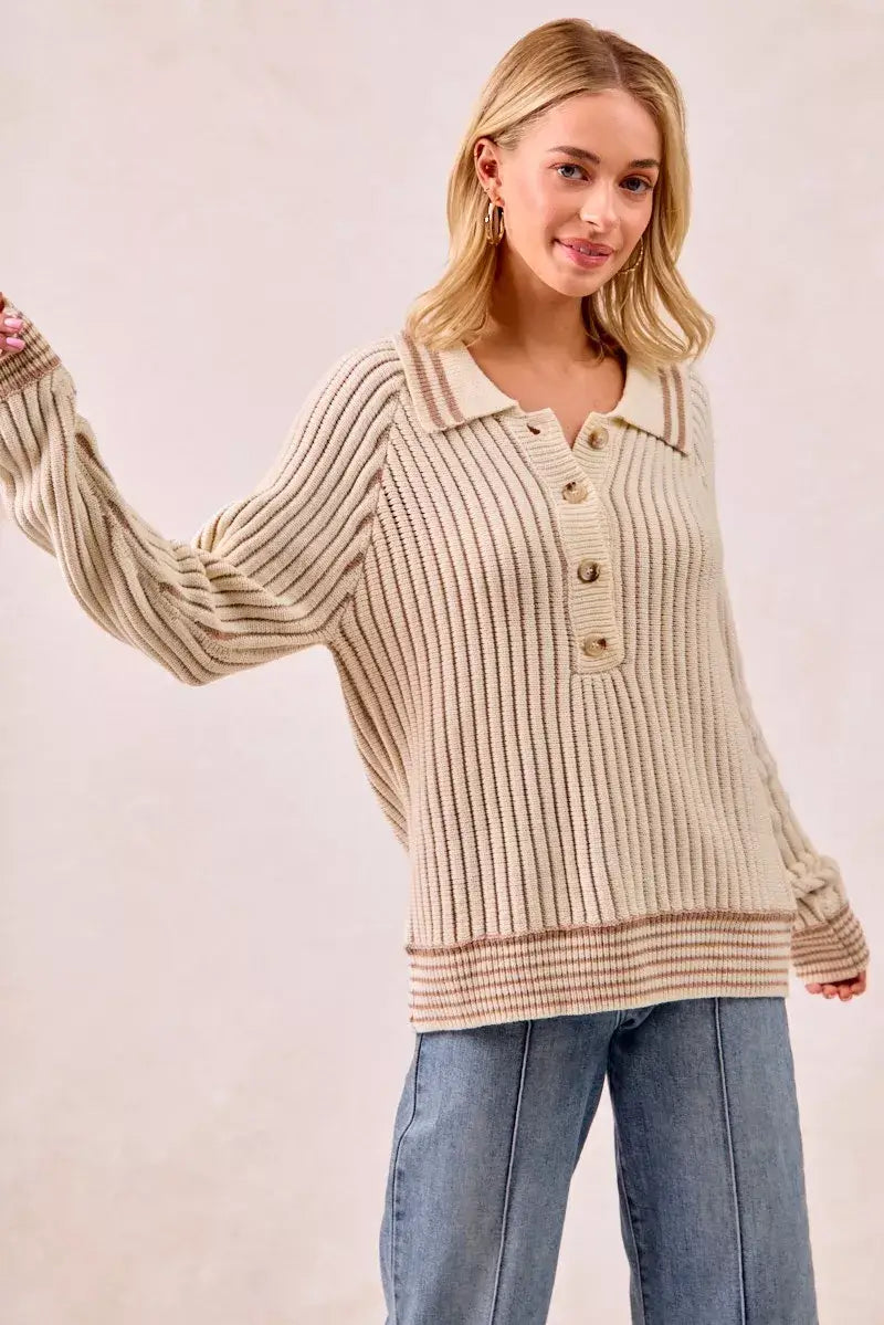 Model wearing a cozy BiBi half button ribbed two tone sweater paired with jeans.