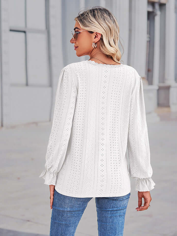 Back view of a woman wearing an Eyelet V-Neck Flounce Sleeve Blouse with flounce sleeves and a delicate eyelet pattern.