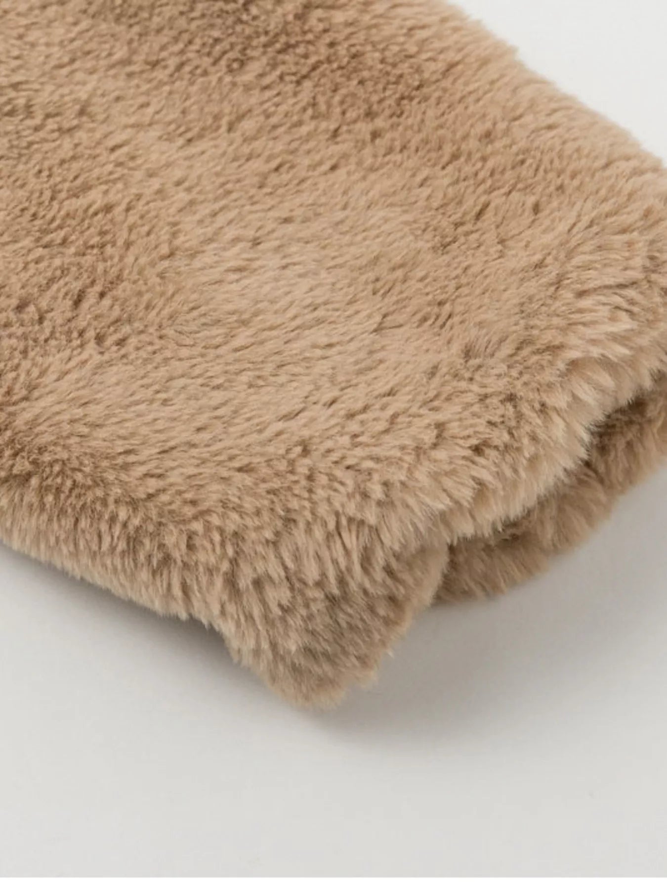 Close-up of plush fabric showcasing the soft texture of the Faux Fur Cropped Zip-Up Jacket.
