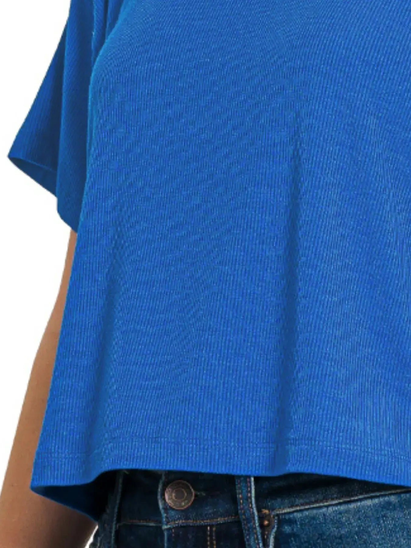 Blue ribbed round-neck crop t-shirt paired with high-waisted jeans, showcasing a relaxed fit and soft texture.