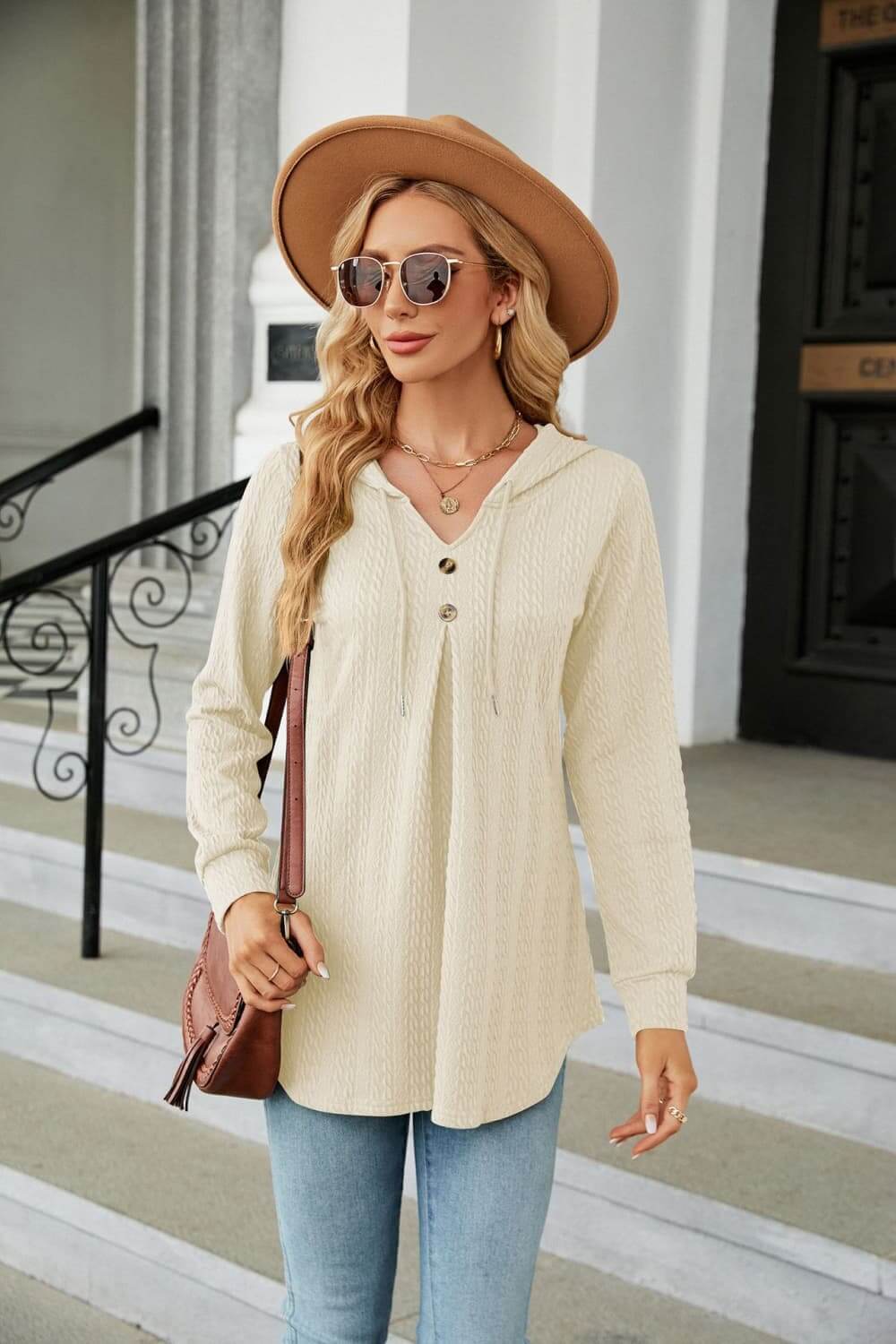 Long Sleeve Hooded Blouse in cream with tie-neck, styled casually with sunglasses and a hat.