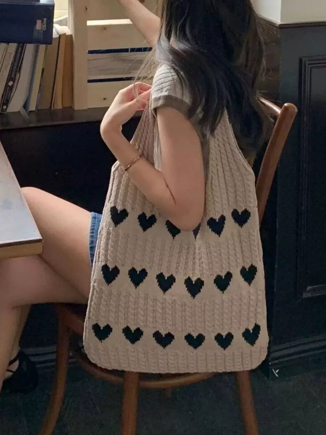 Heart Pattern Knitted Handbag showcased in a casual setting, featuring a stylish design and medium size for everyday use.