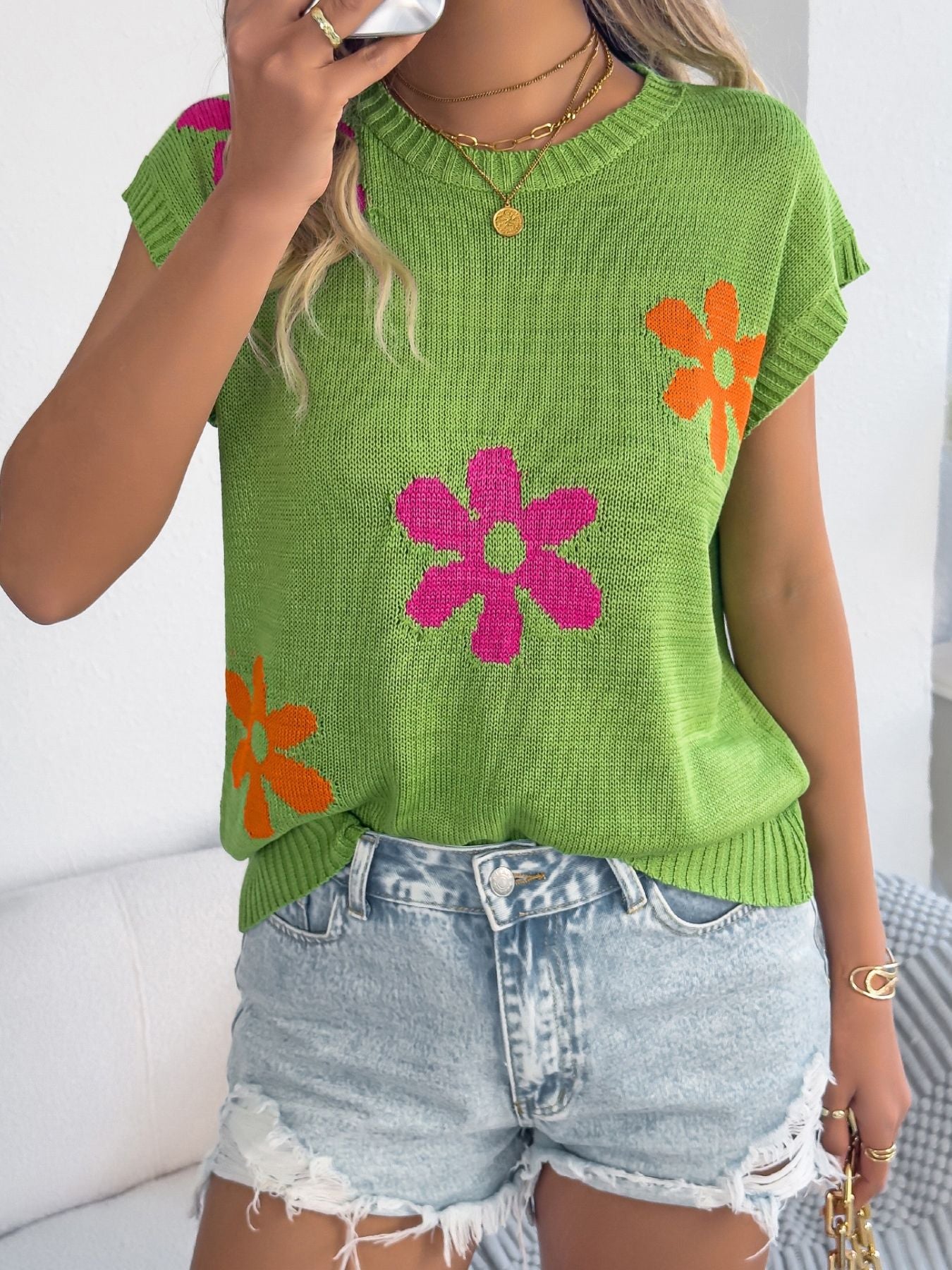 Flower Round Neck Sweater in green with colorful floral design, worn with denim shorts for stylish casual look.