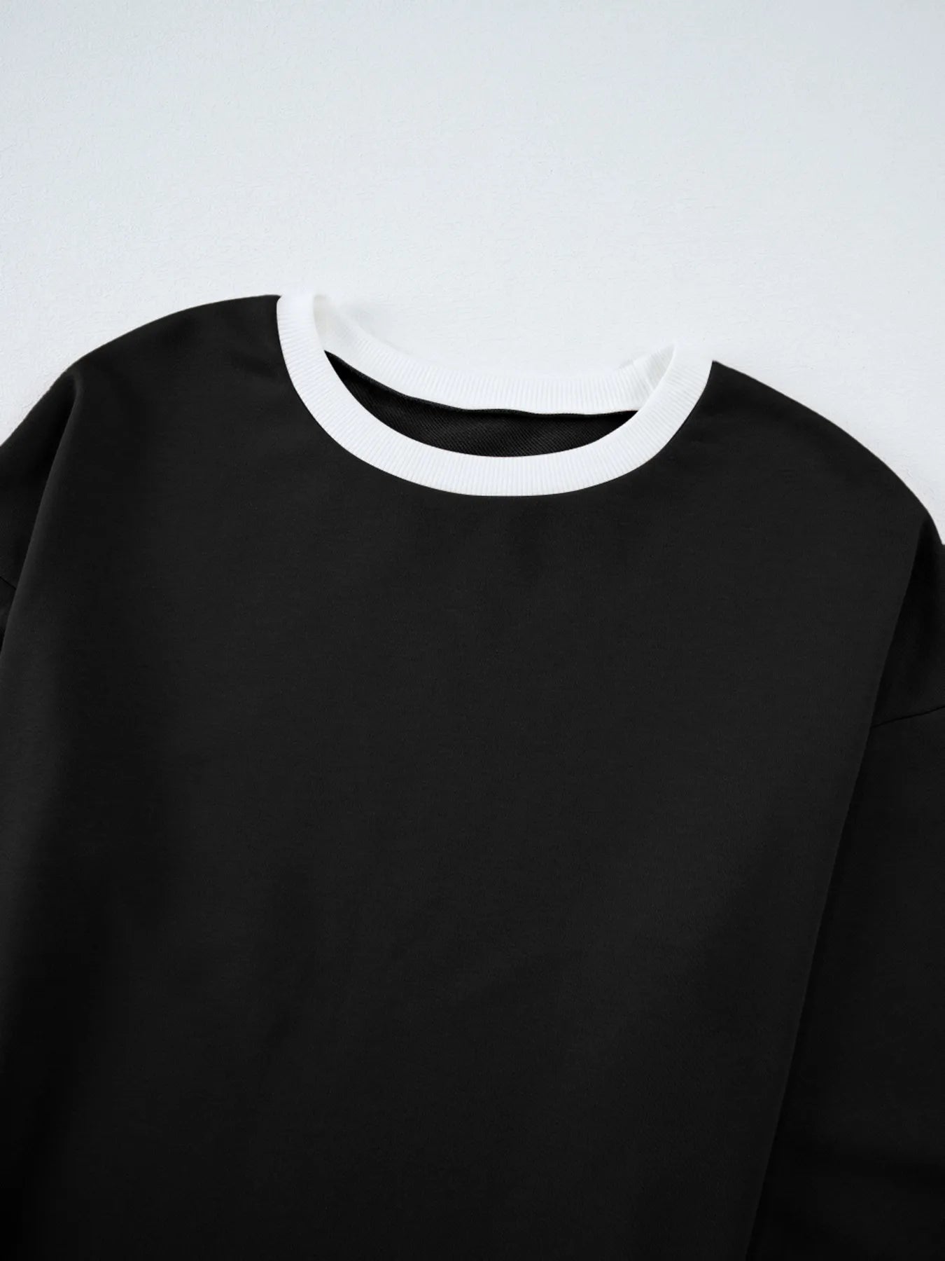 Contrast Trim Round Neck Top and Pants Set featuring a close-up of the round neck design in black with white trim.