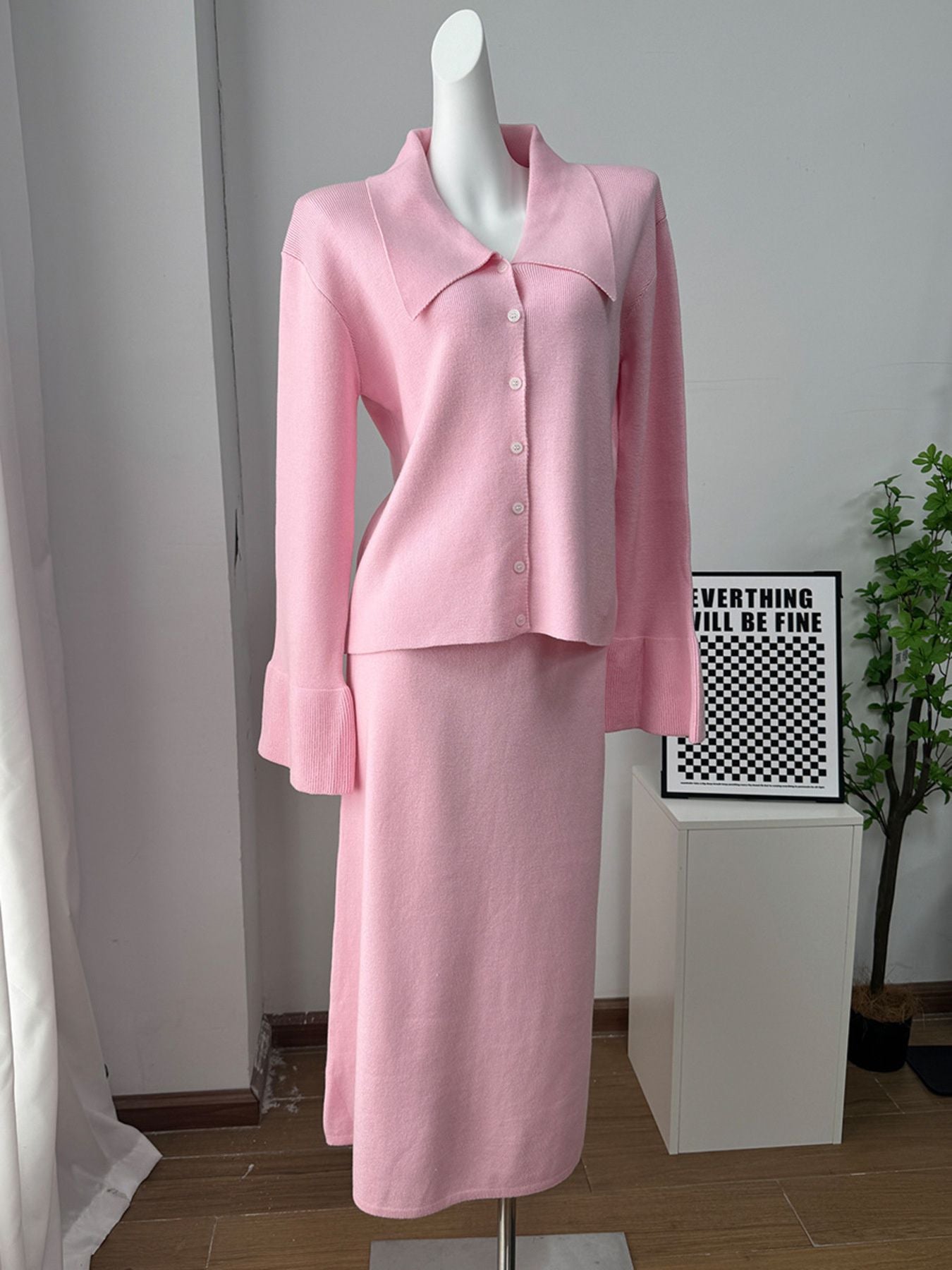 Button Down Cardigan and Skirt Knit Set displayed on a mannequin in soft pink, featuring a buttoned ribbed cardigan and matching skirt.