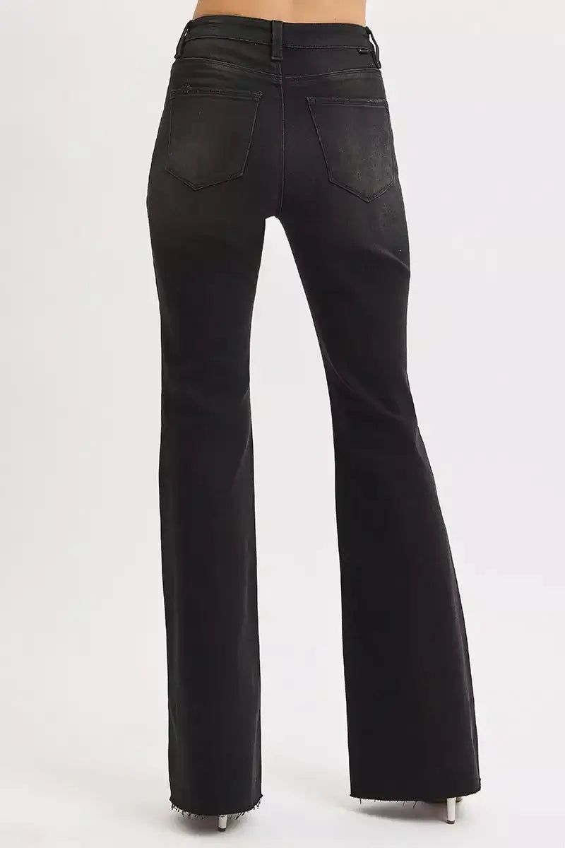 Back view of RISEN Full Size High Rise Flare Raw Cut Hem Jeans in black, showcasing the flattering flare design and raw hem.