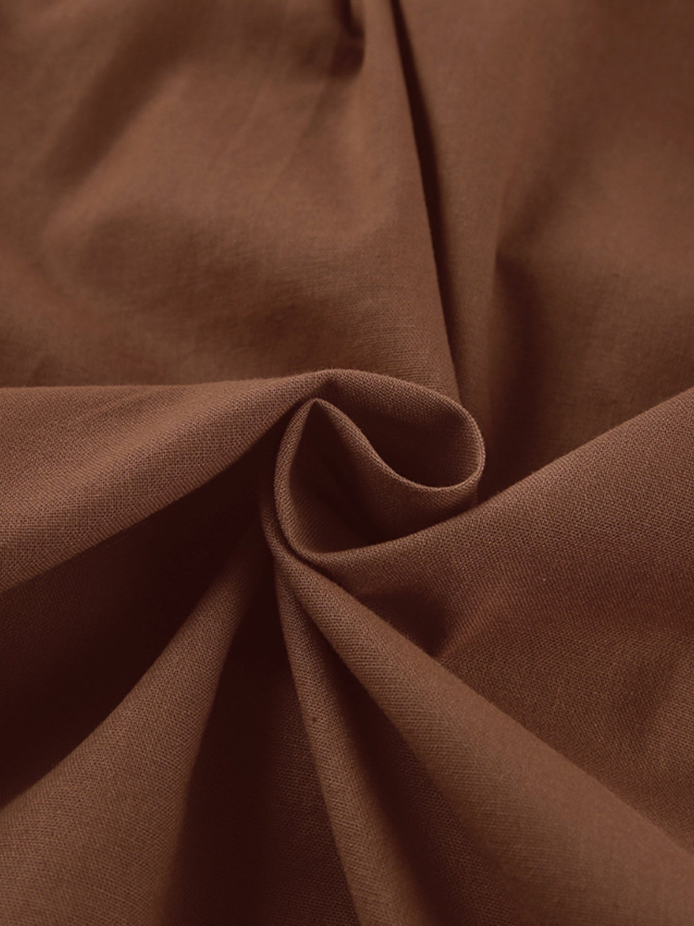 Close-up of 100% cotton fabric used in One Shoulder Top and Shorts Set, showcasing its soft texture and brown color.