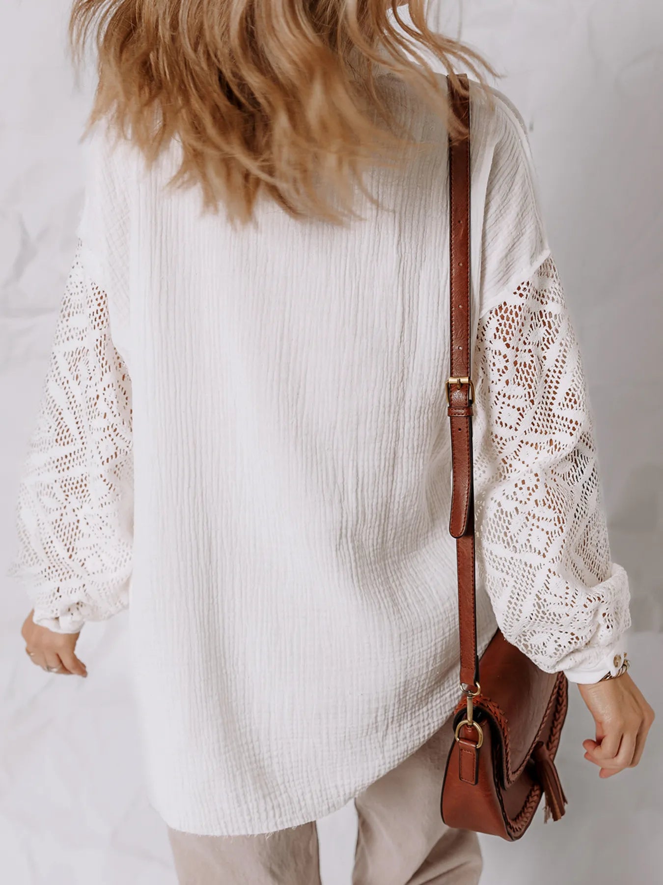 Lace Sleeve Button Down Shirt featuring eyelet lace sleeves and a relaxed fit, styled with a brown crossbody bag.