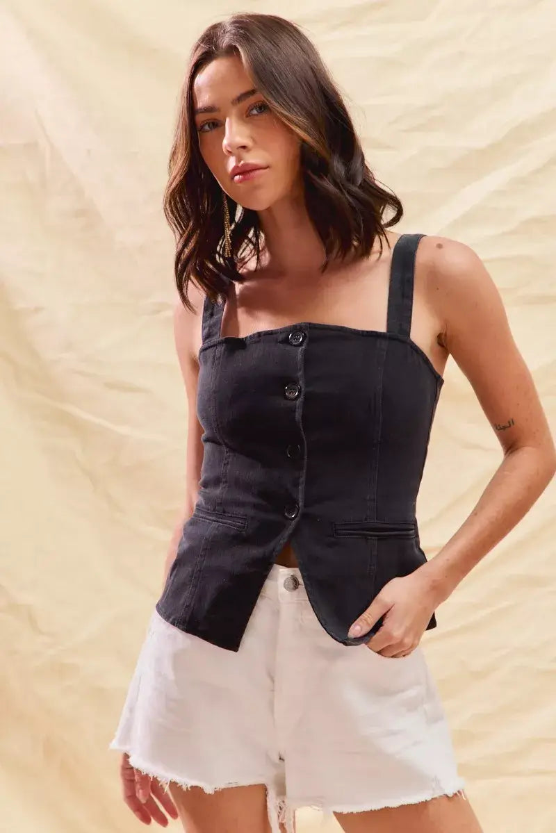 Model wearing SO ME button down sleeveless denim top with shorts against a beige background.