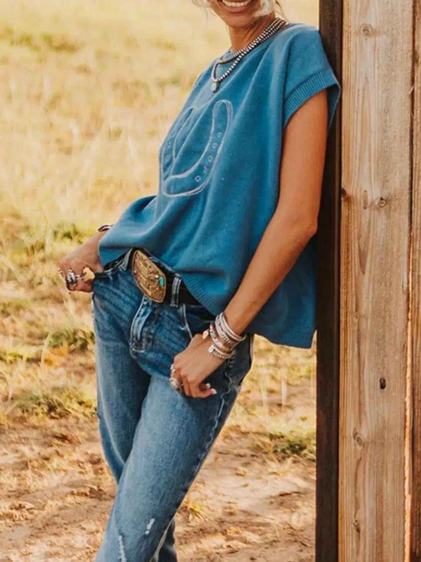 Horseshoe Graphic Round Neck Short Sleeve Top styled with blue jeans, showcasing casual chic fashion.