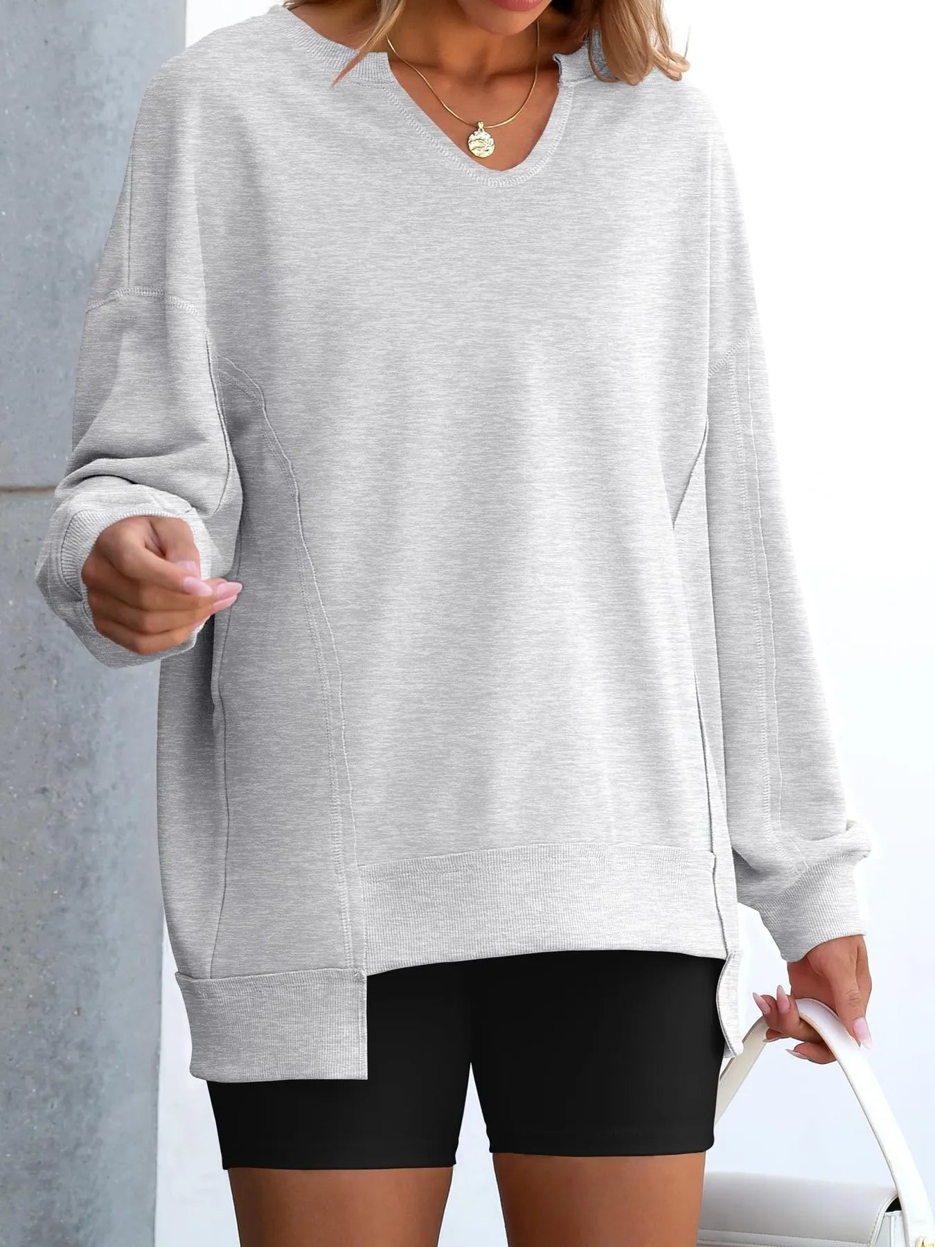 Notched Long Sleeve Oversized Sweatshirt in gray worn as casual outfit with black shorts