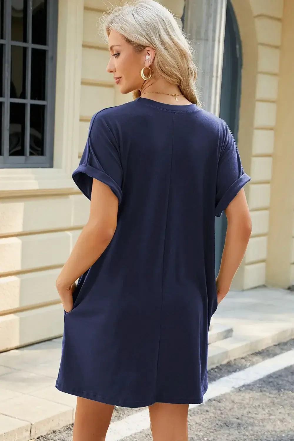 Back view of a navy blue Round Neck Rolled Short Sleeve Tee Dress with pockets, showcasing a relaxed fit and rolled sleeves.