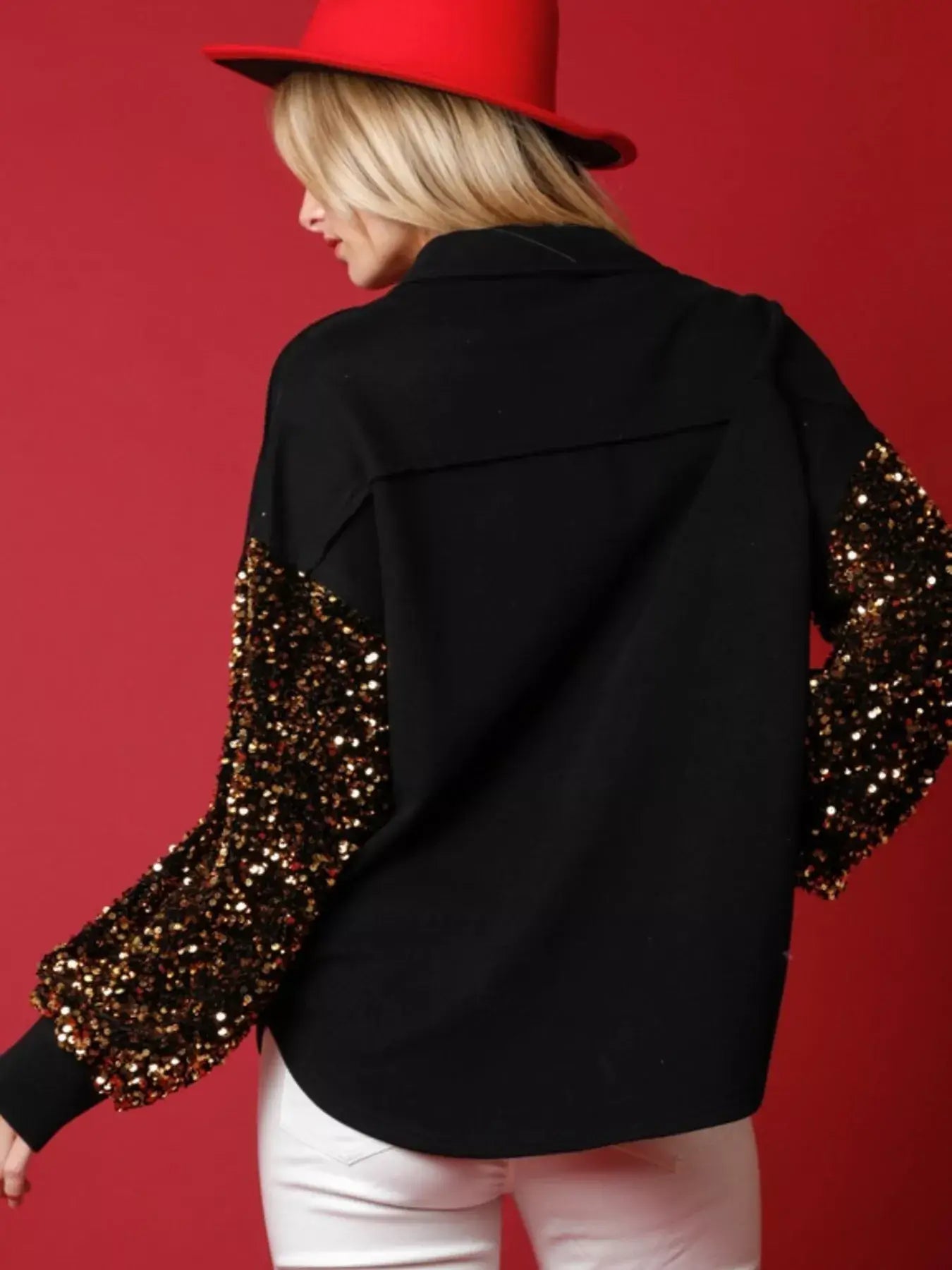 Stylish model wearing a Christmas Santa sequin long sleeve shirt with sparkling sleeves against a festive backdrop.