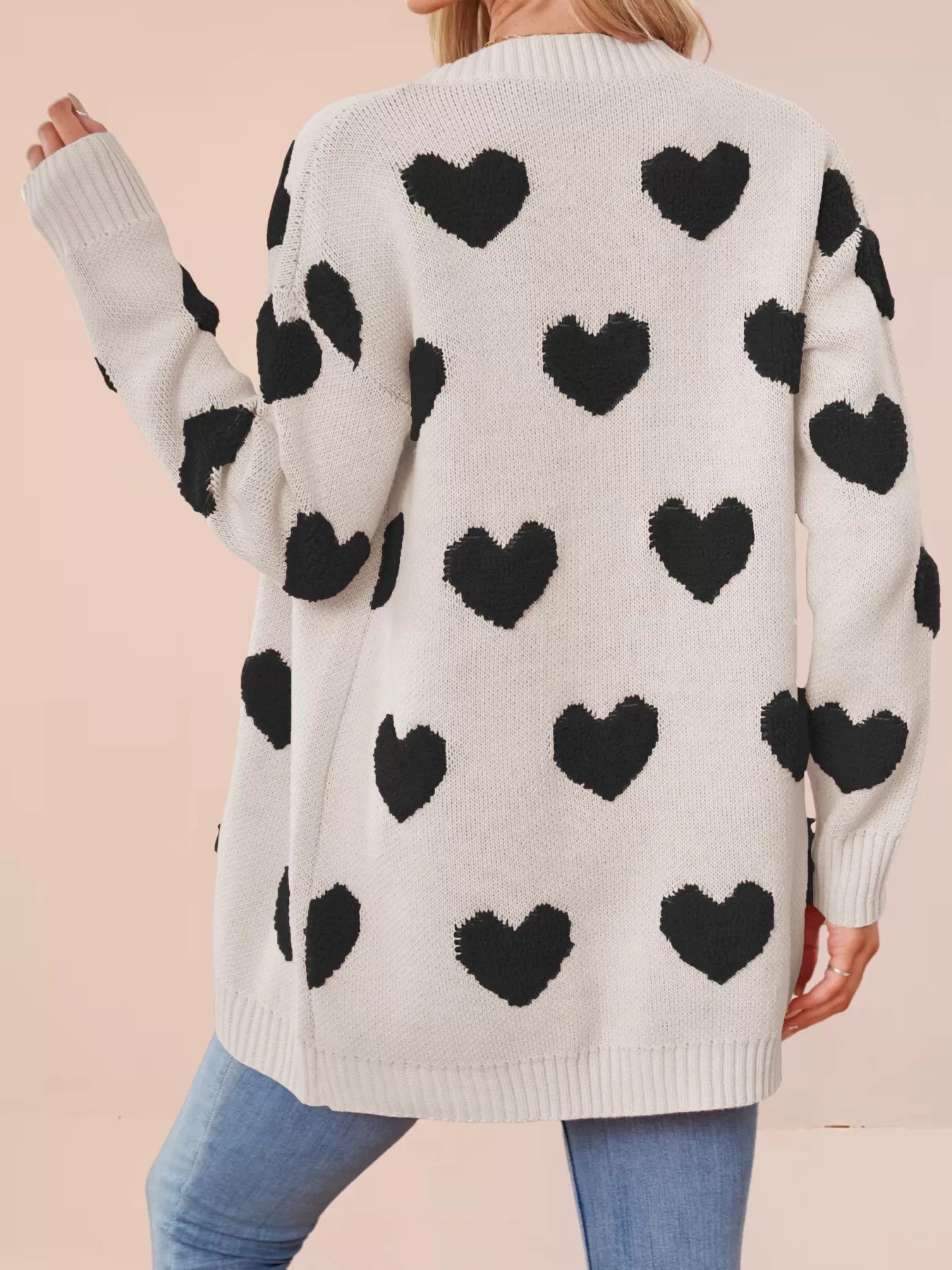 Heart Pattern Knit Button Up Cardigan back view with black hearts on a light fabric.