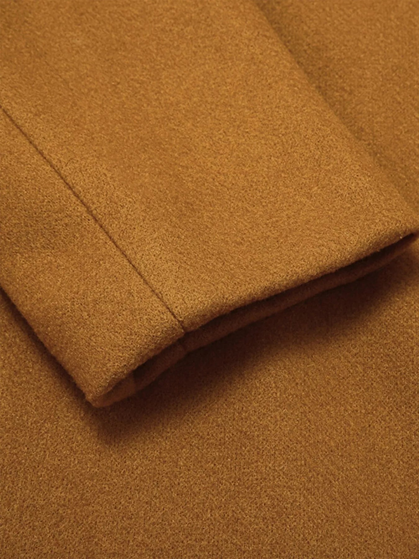 Close-up of the sleeve fabric of a Full Size Single Breasted Long Sleeve Overcoat for Women in a warm brown color.