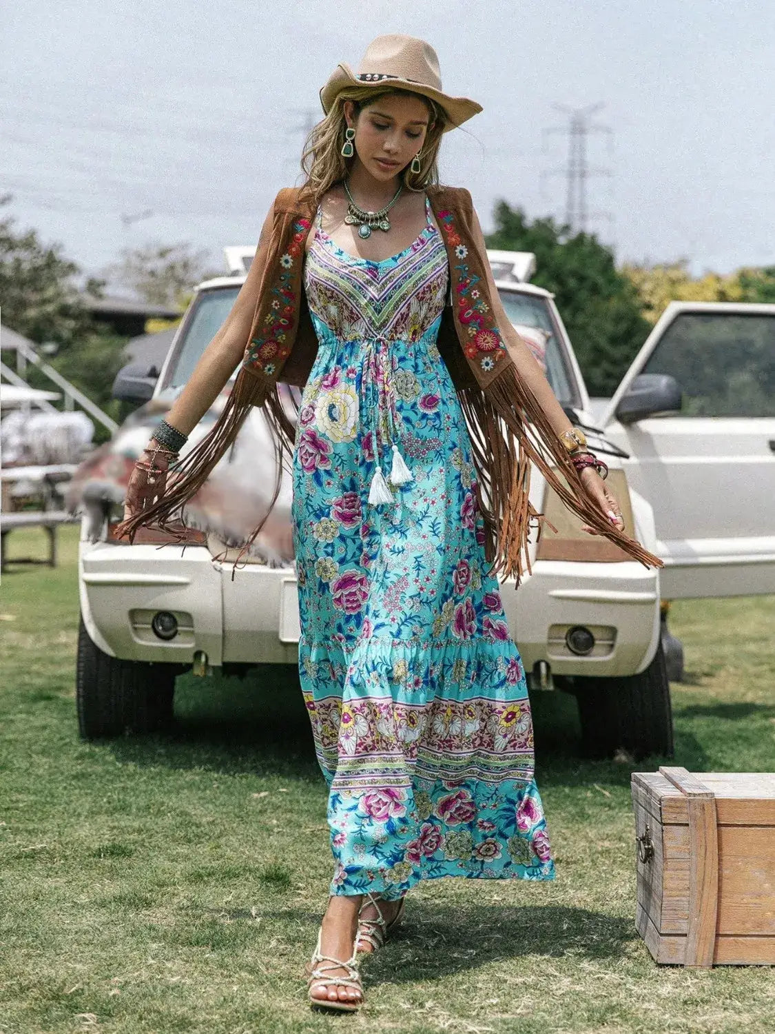 Tassel Floral Print Tiered Cami Dress styled with a boho vest and hat in a summer outdoor setting.