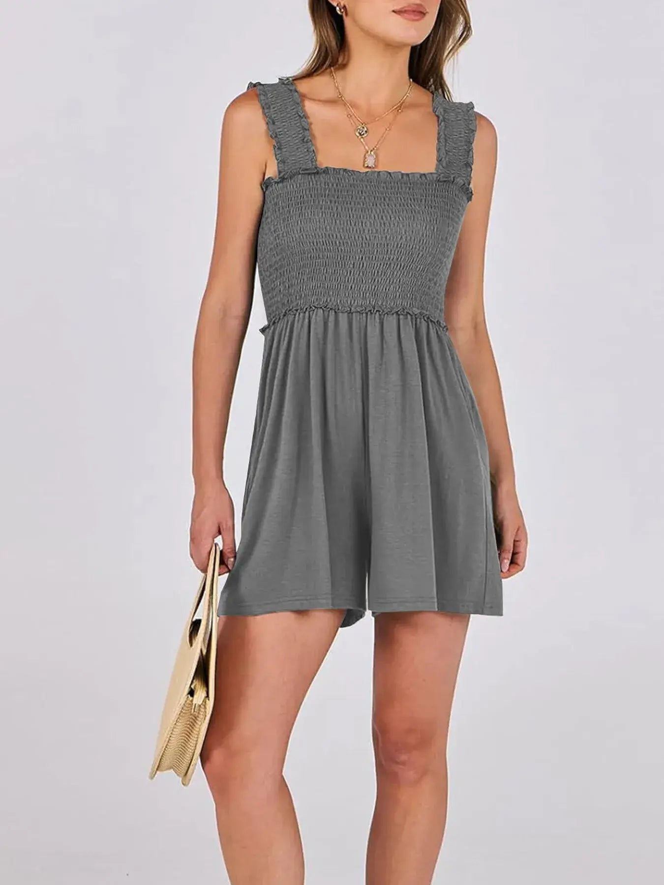 Woman wearing a Smocked Square Neck Summer Romper in grey with ruffled edges and a stylish look.