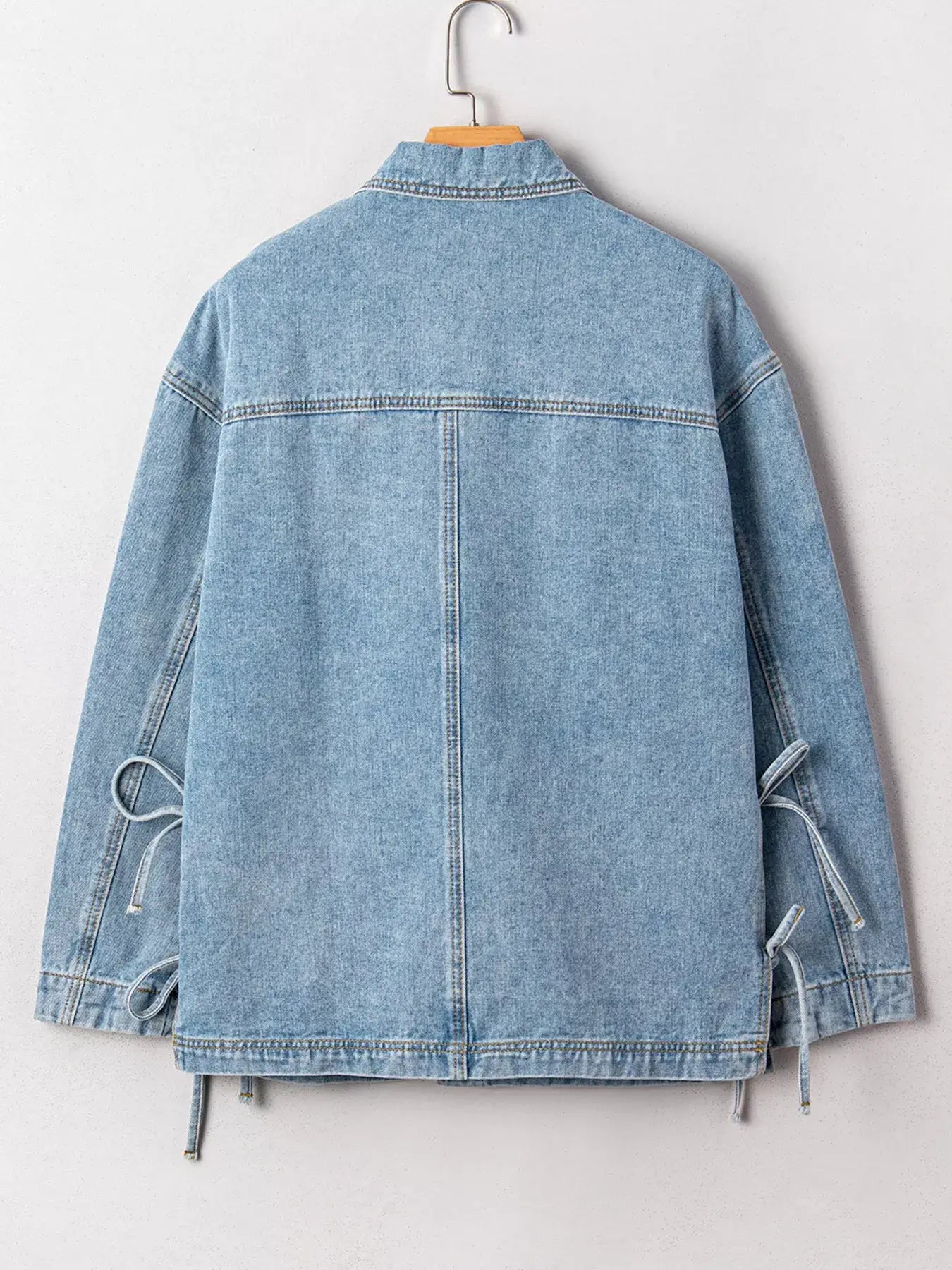 Back view of a stylish Patched Pockets Side Tie Denim Jacket for women, showcasing its unique design and casual look.