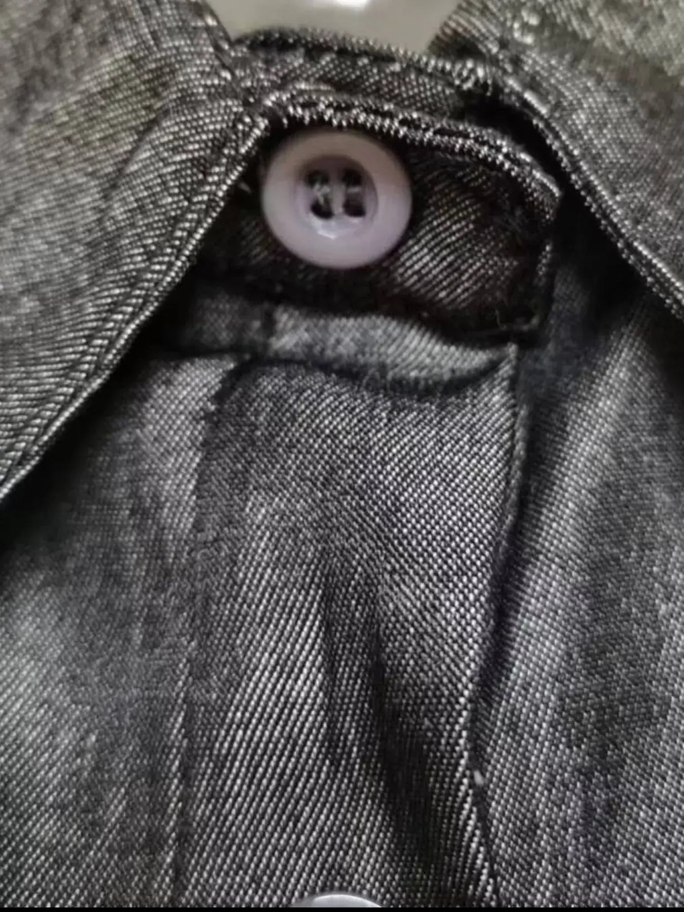 Close-up of the button and collar detail on a Full Size Button-Down Maxi Denim Dress, showcasing denim texture and craftsmanship.