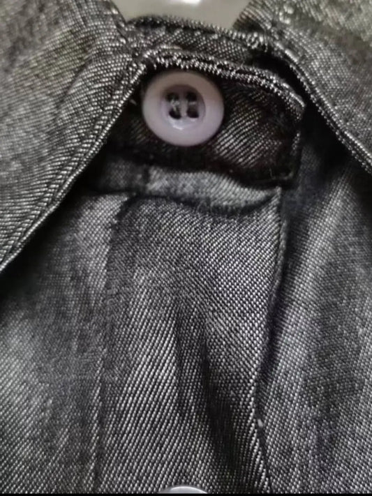 Close-up of the button and collar detail on a Full Size Button-Down Maxi Denim Dress, showcasing denim texture and craftsmanship.
